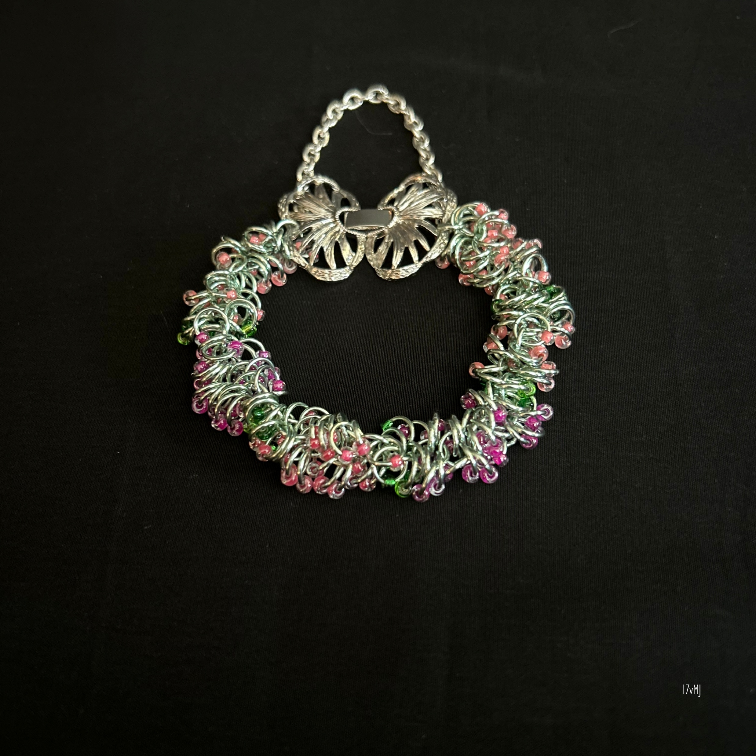 “Hello Springtime bracelet laid flat in a round shape with the butterfly clasp visible.”