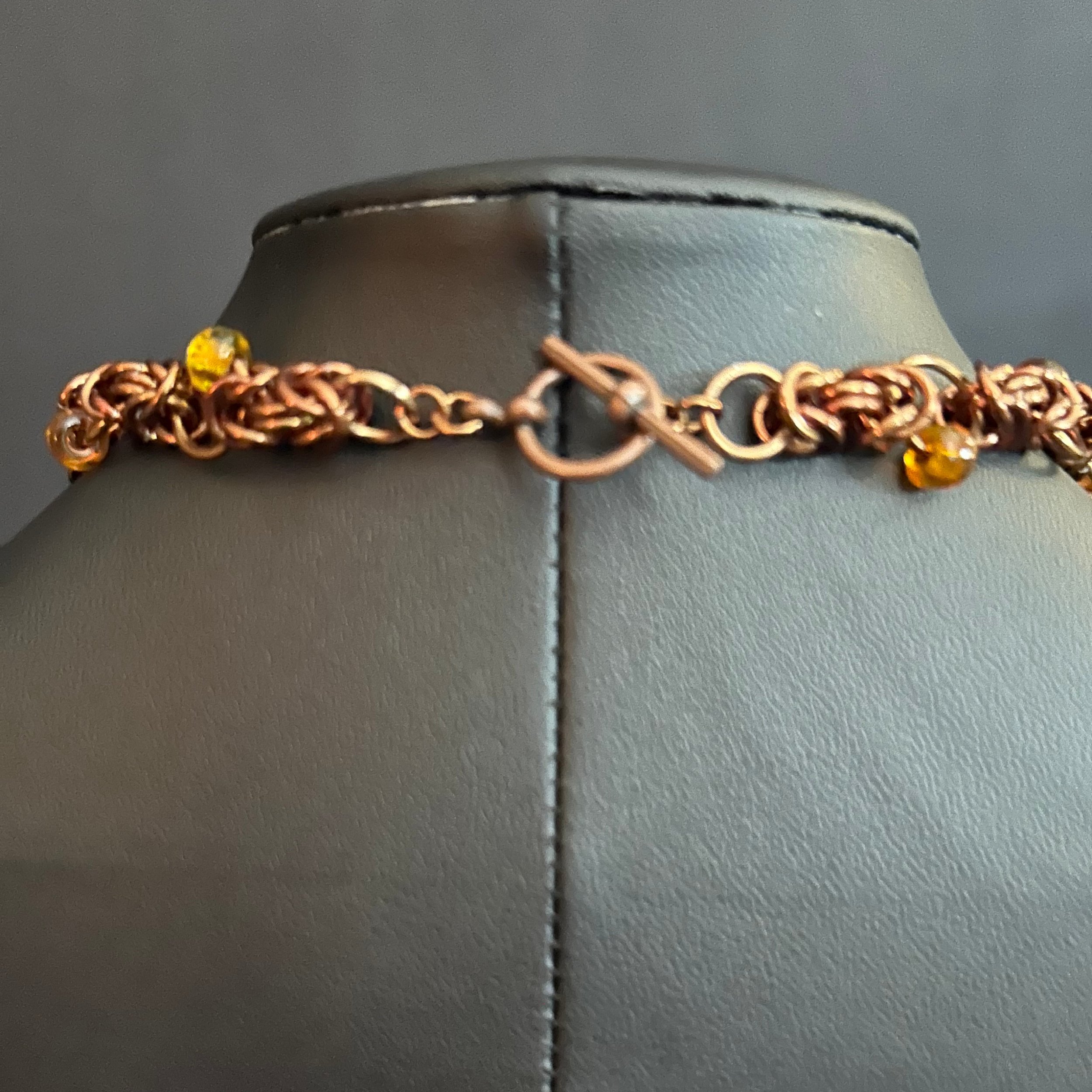 “Close-up of the bronze toggle clasp and connecting rings.”