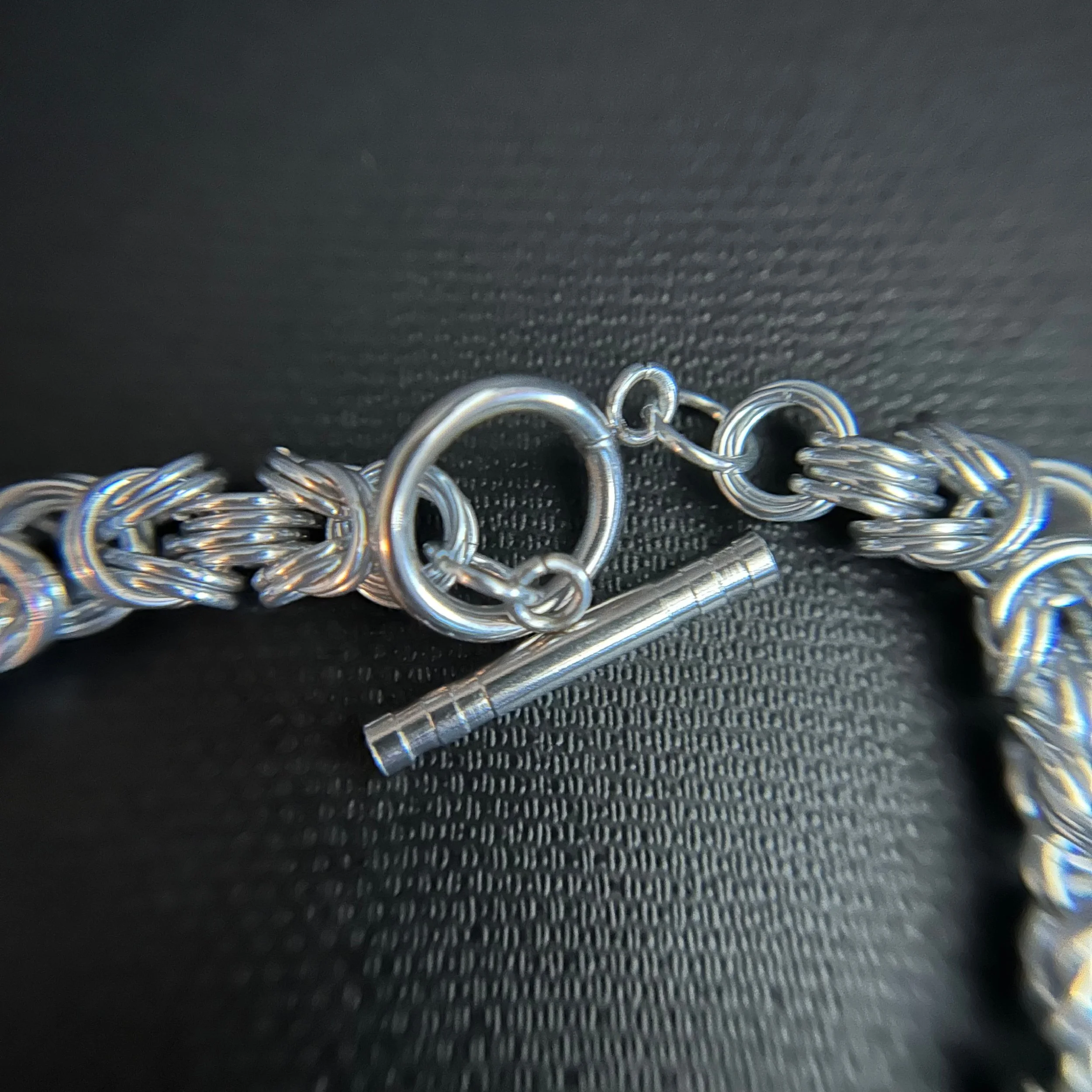 “Close-up of the silver toggle clasp and connecting rings.”