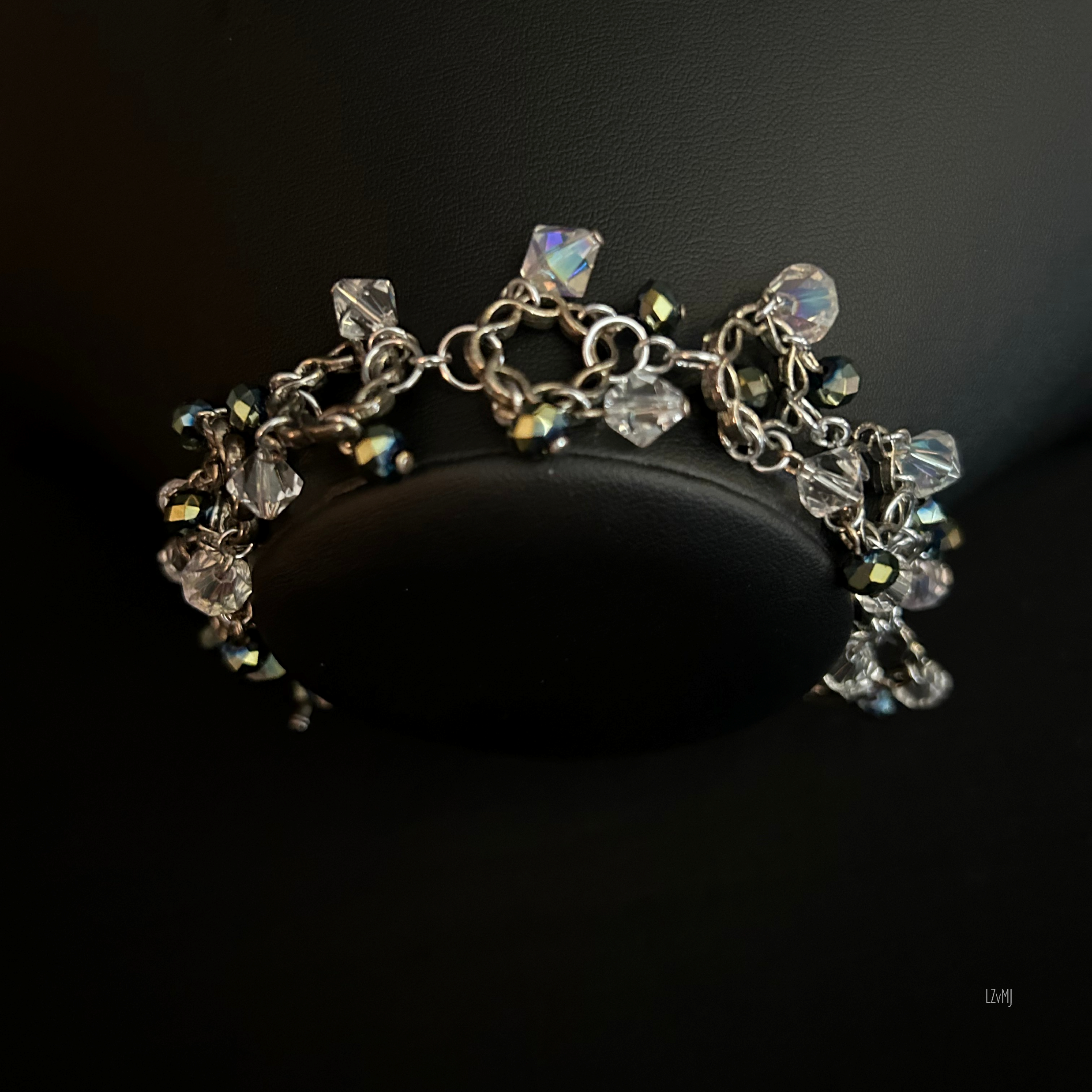 Bracelet on display bust, highlighting the twisted circles and layered crystal charm