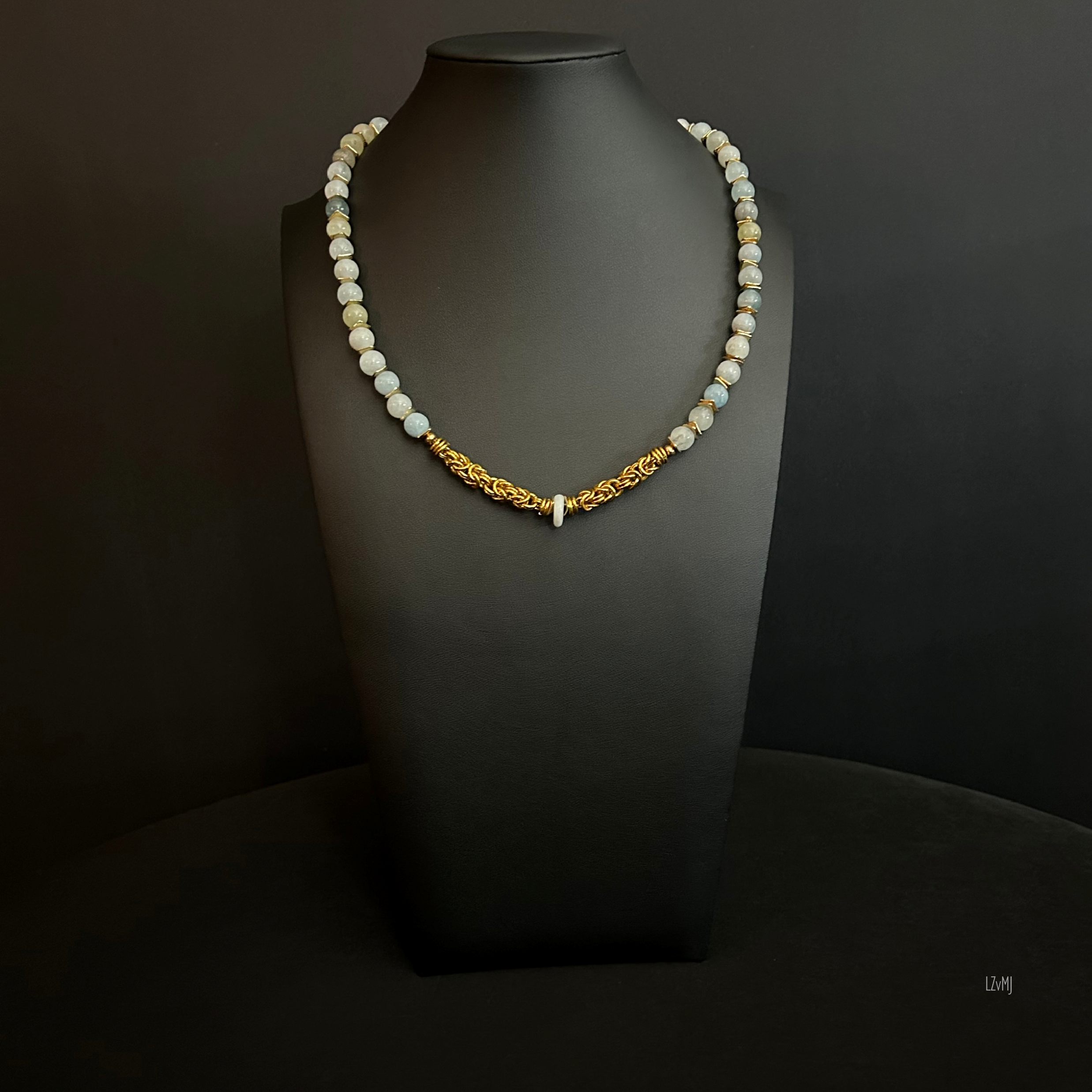 “Full view of the Golden Aquamarine necklace with aquamarine beads, gold spacers, and aluminum chain.”