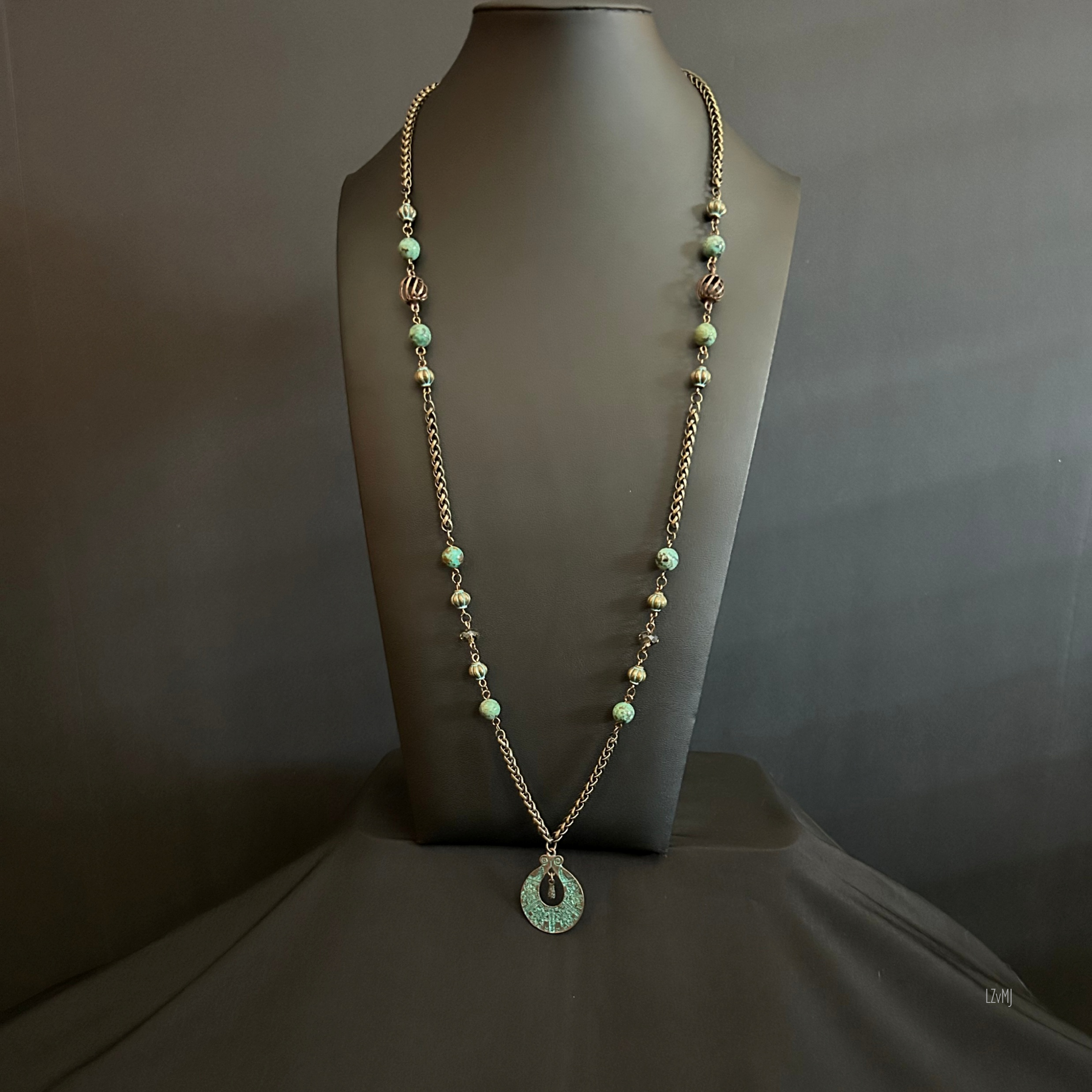 “Full view of the African Turquoise necklace with bronze chain and patina pendant.”