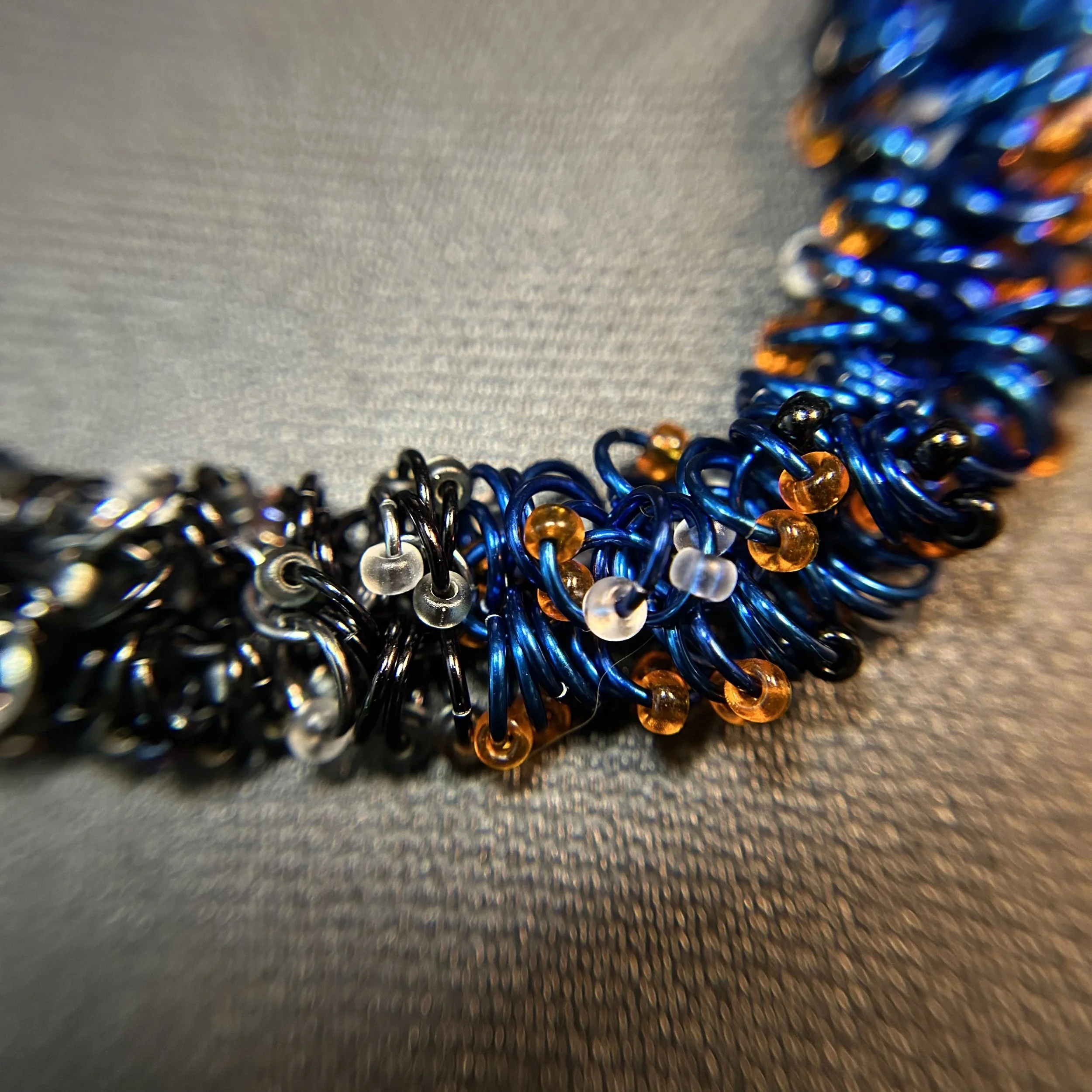 Closeup of the bracelet’s color gradient, focusing on the vivid royal blue rings blending into Black Ice and black.