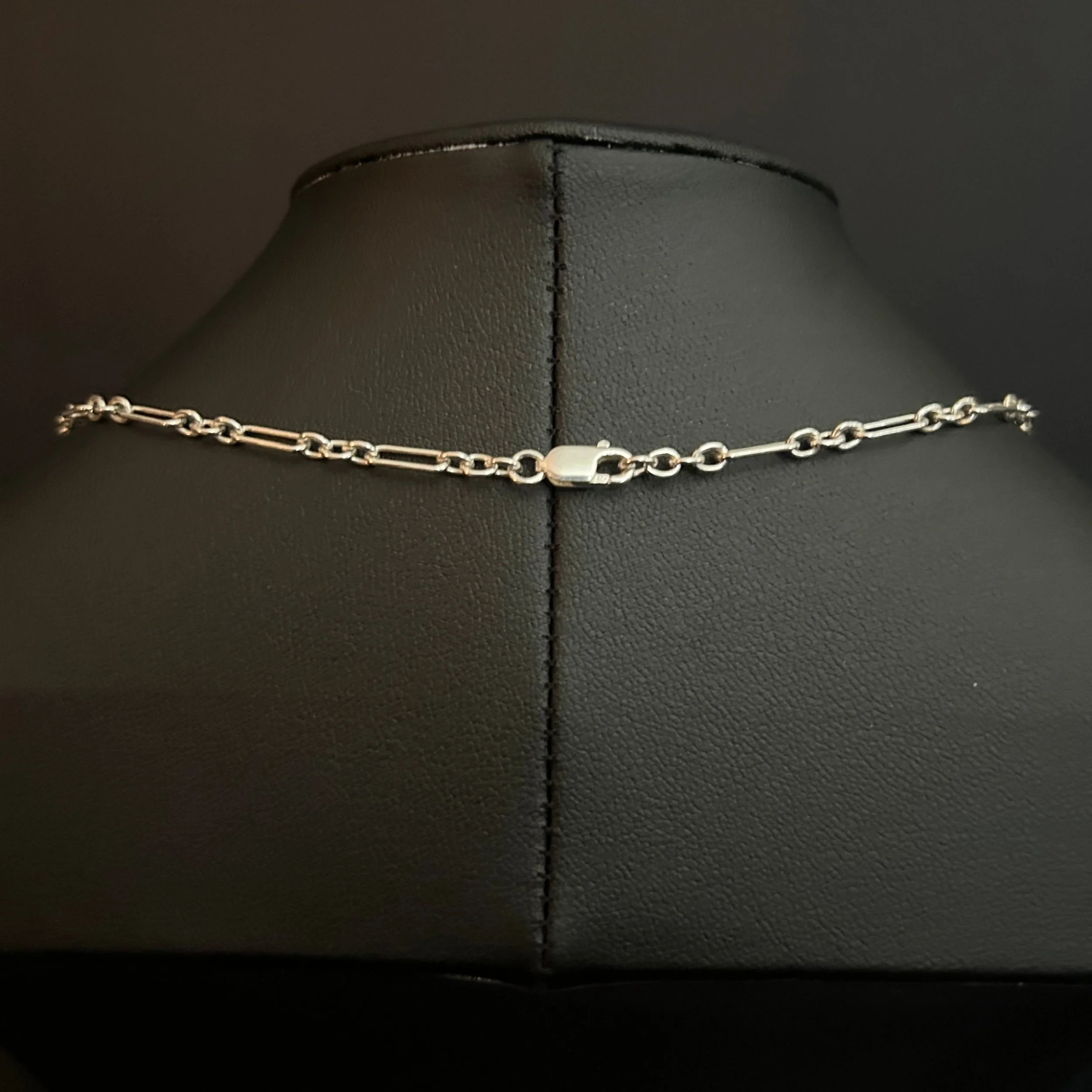 Clasp on the Crystal Whisper Sterling necklace showing the oval silver links and a small iridescent crystal bead