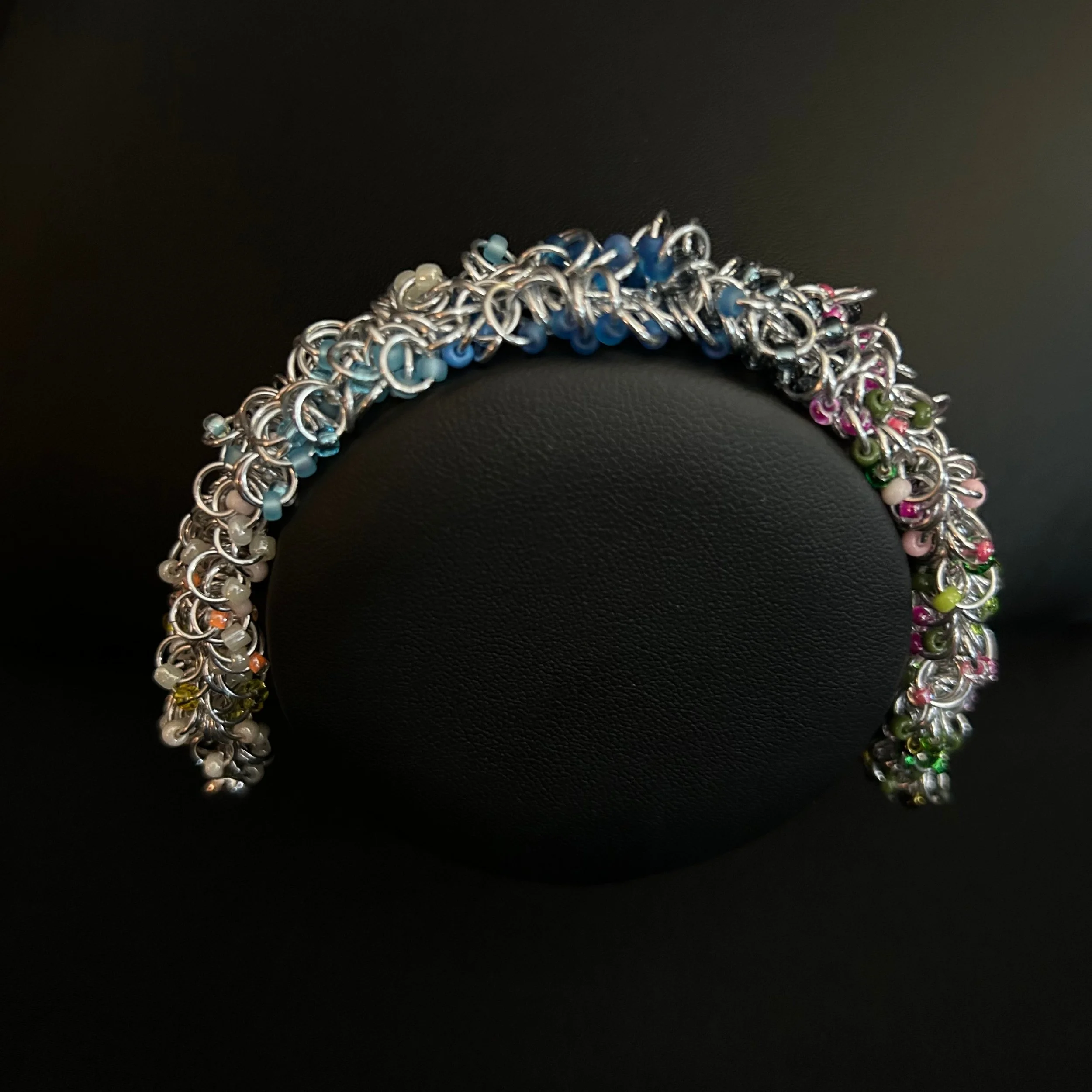 “Blue Ridge Spring bracelet with pastel Miyuki beads displayed on a black jewelry bust.”