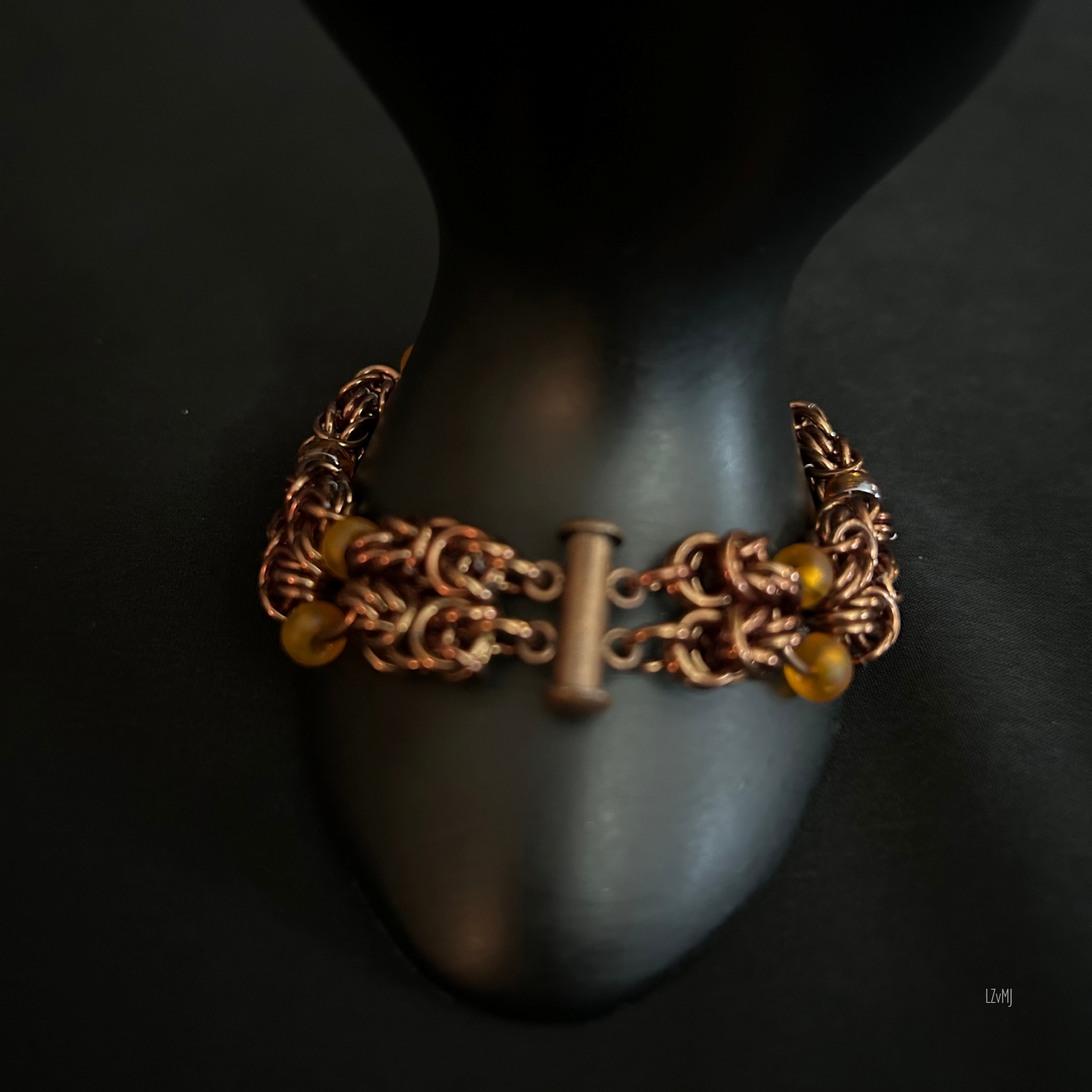“Bracelet on display prop with the bronze slide‑lock clasp clearly visible.”