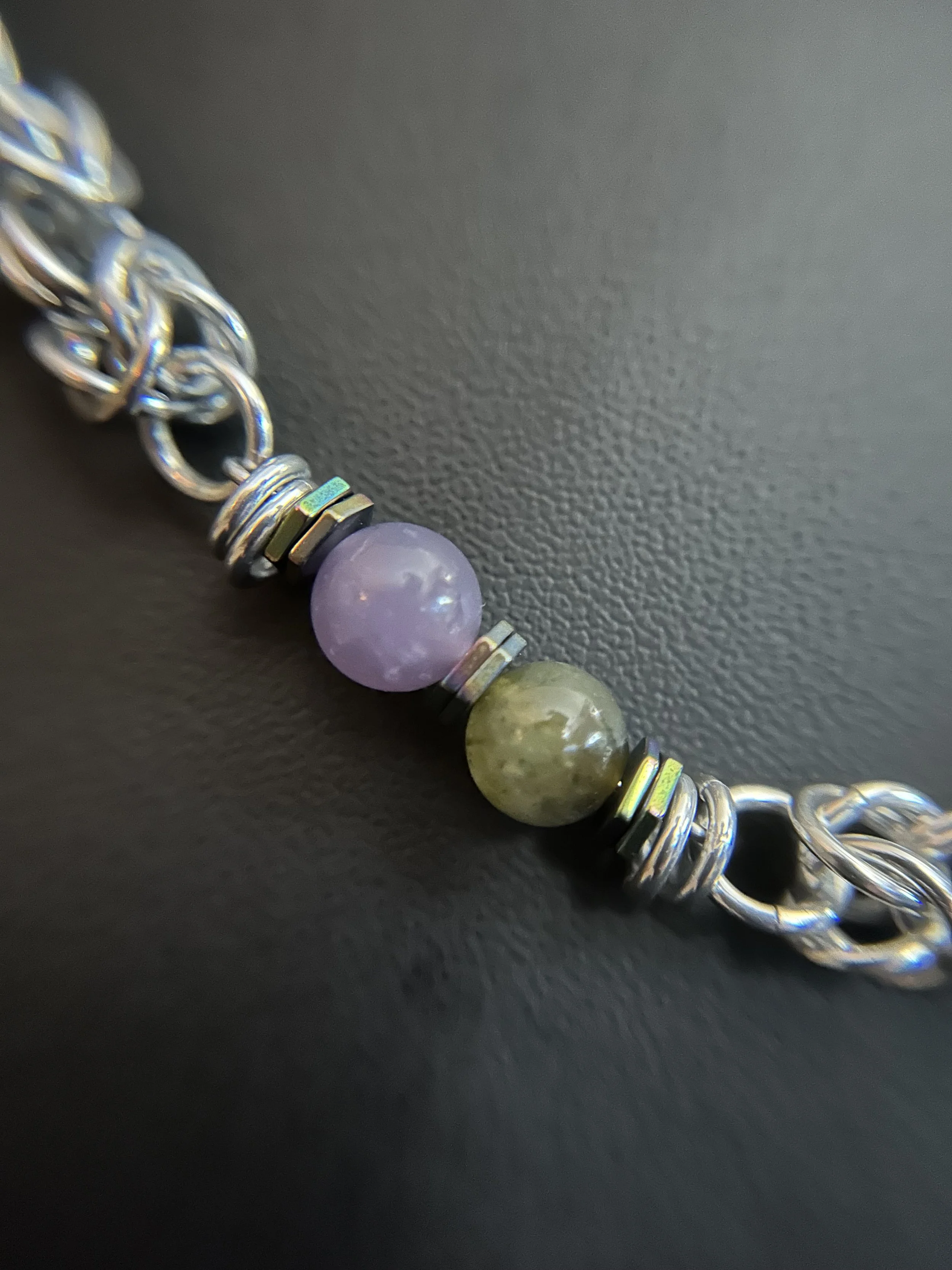 Close‑up of labradorite and lepidolite beads with hematite spacers.