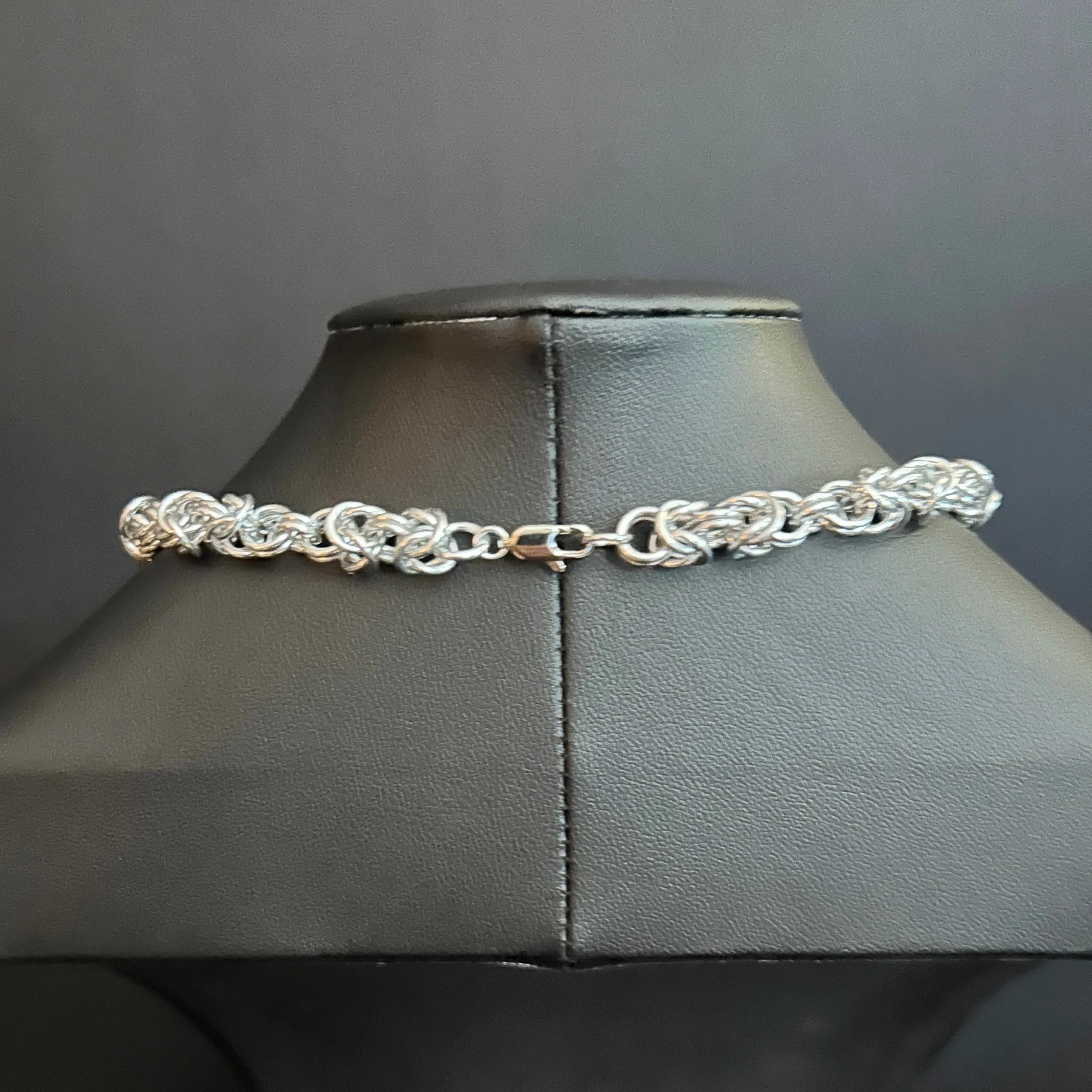 “Close-up of the silver lobster clasp and connecting rings.”