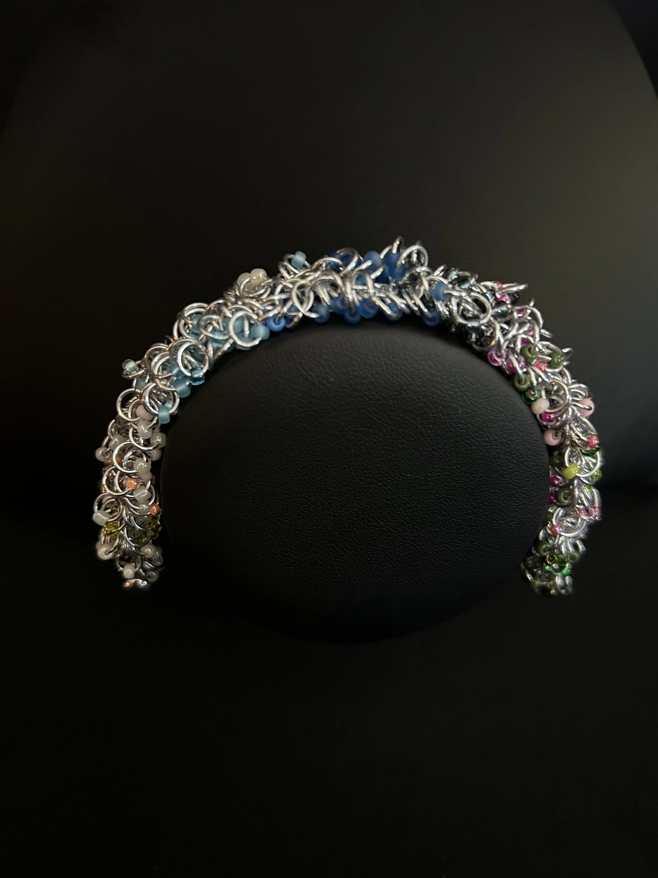 Blue Ridge Spring Bracelet shown on a black jewelry bust to display scale and drape.