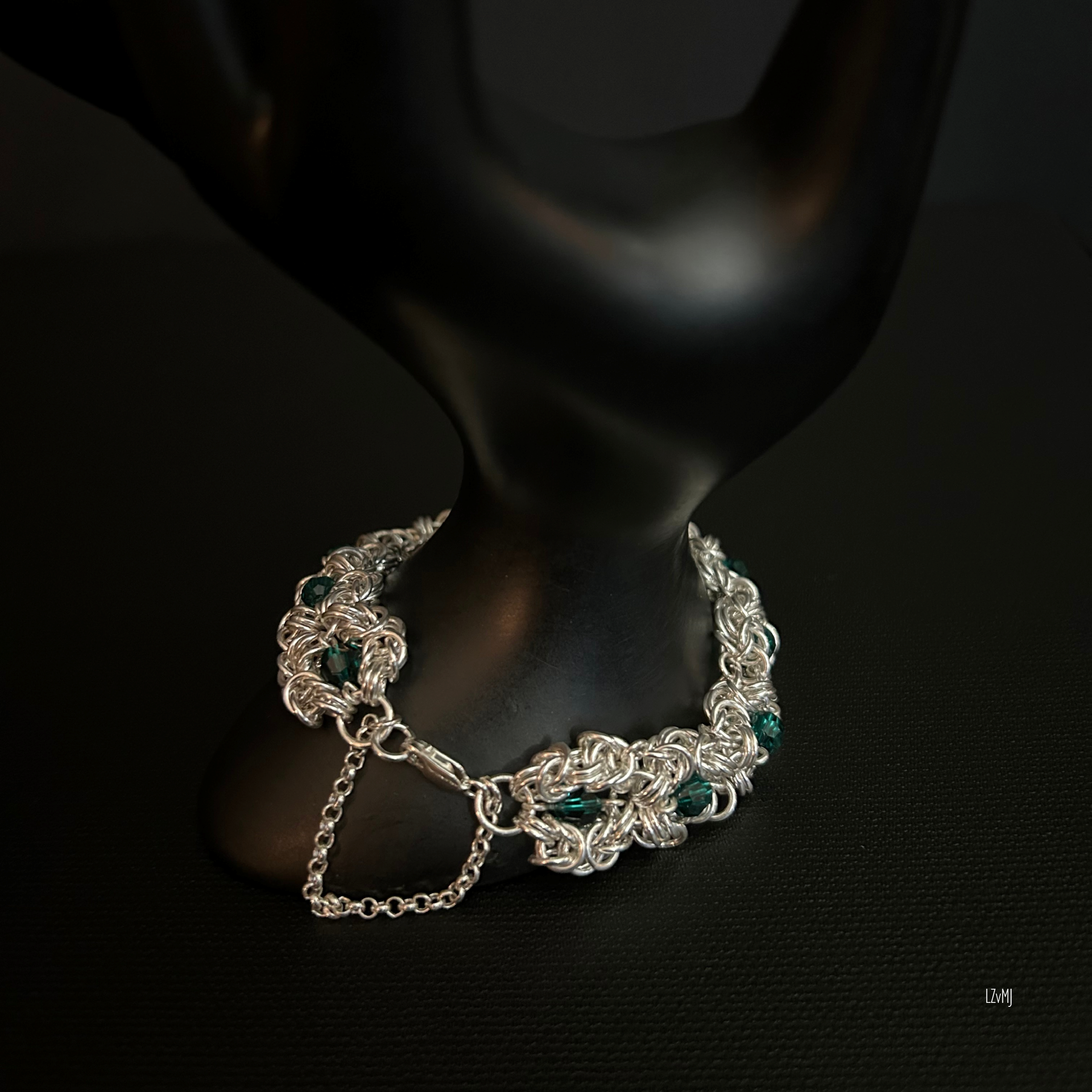 Close-up of the sterling clasp and safety chain resting against the prop