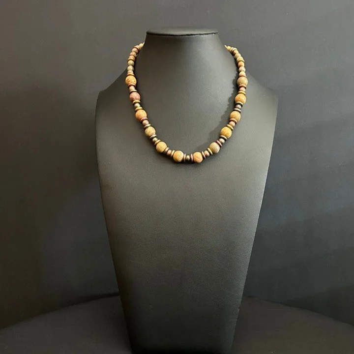 “Full view of jasper bead necklace with glass rondelles and bronze toggle clasp.”
