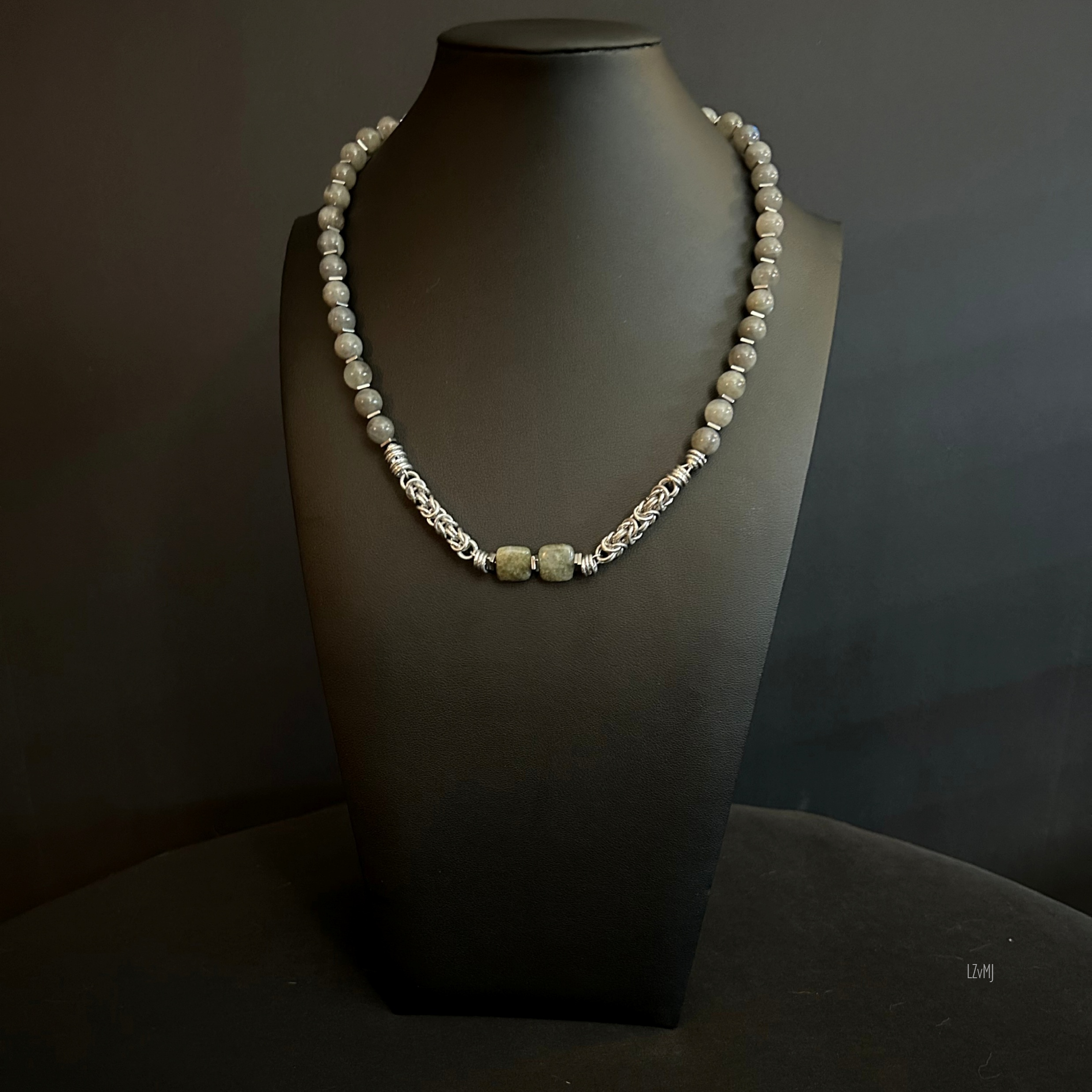 Moonline necklace displayed on a black bust, featuring labradorite rounds, square focal stones, and silver chainmaille accents