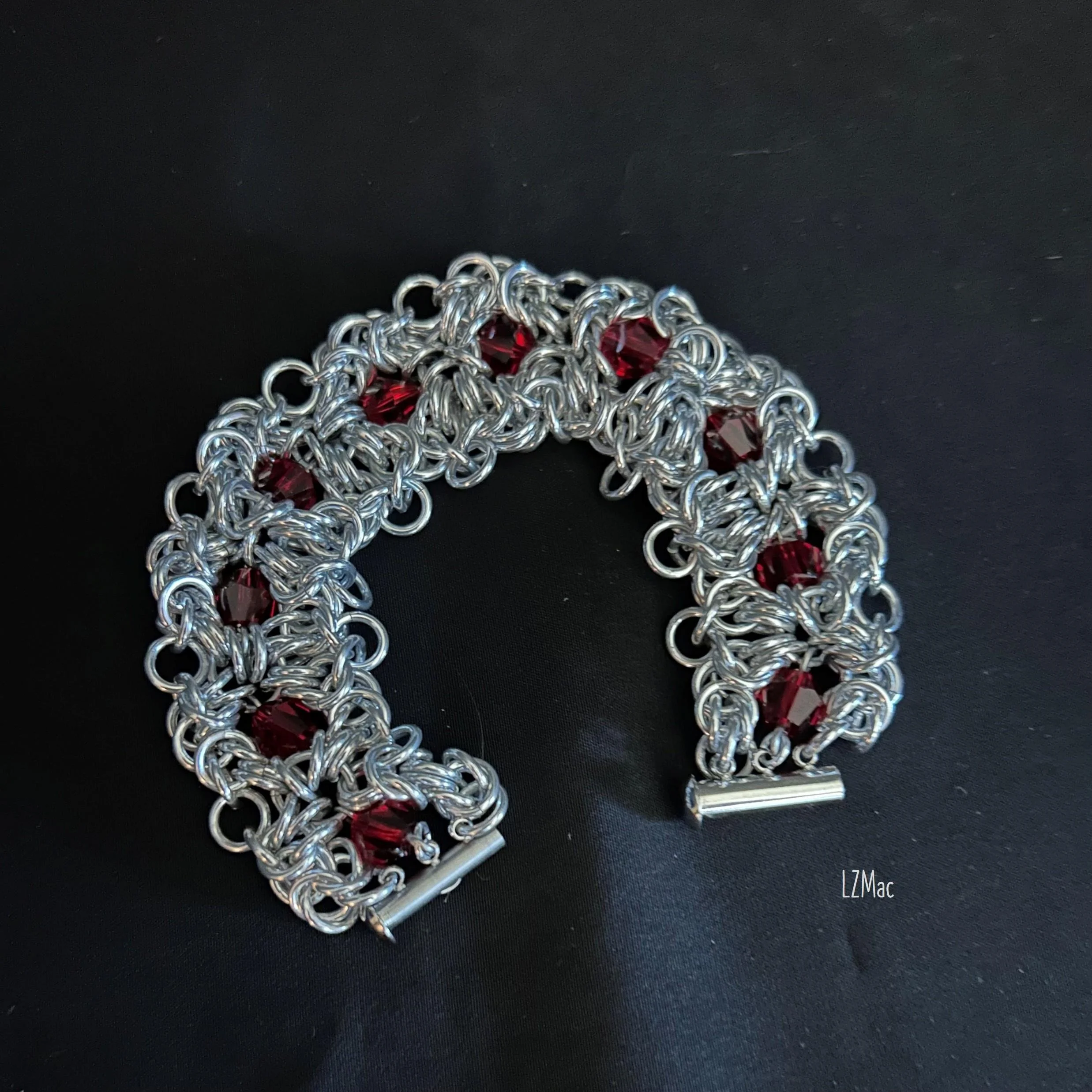 Ruby Frost chainmaille bracelet laid flat showing open clasp and full weave design