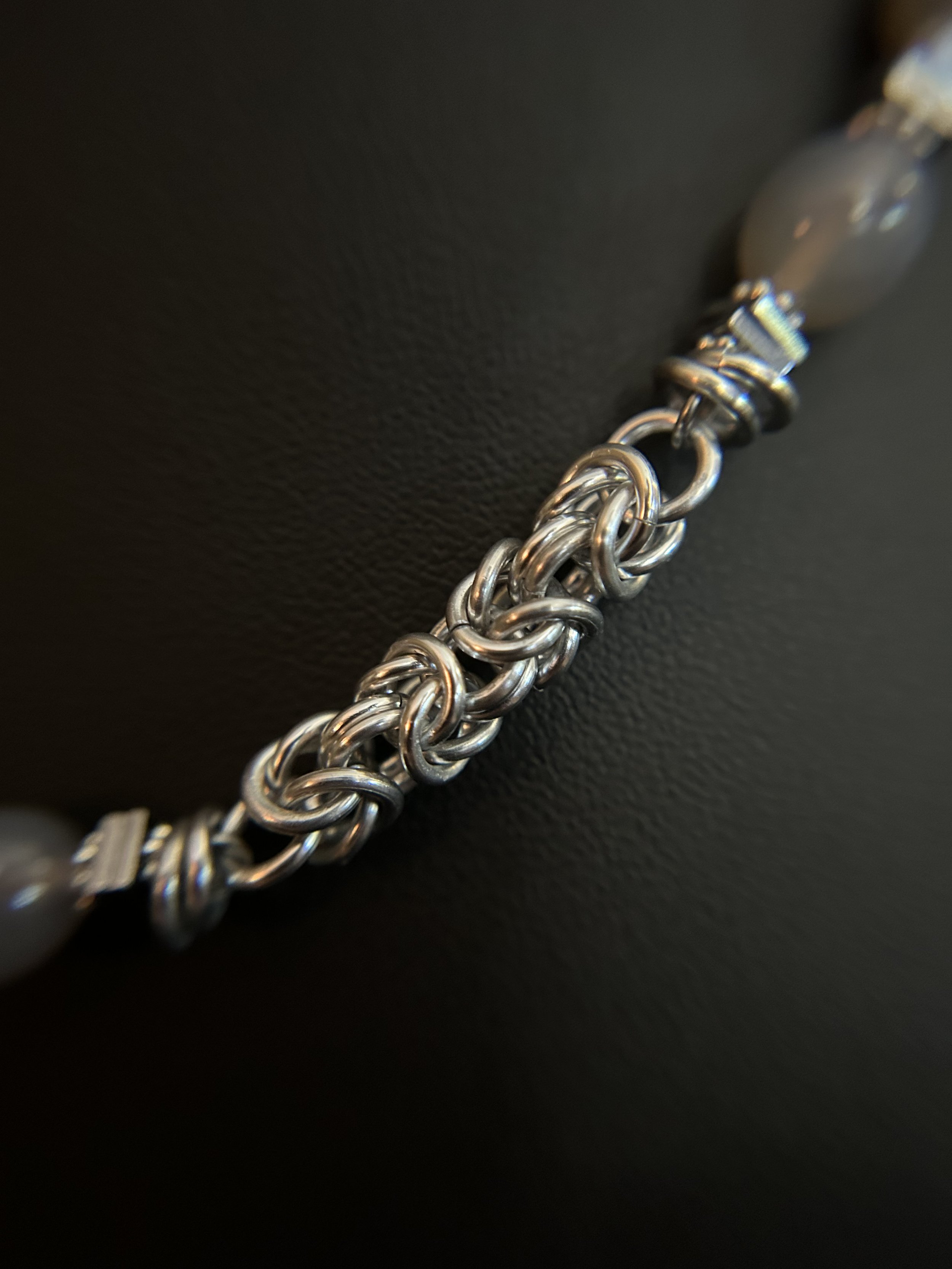 Detailed view of handwoven aluminum chainmaille links showing the bright, intricate weave pattern of the Moonlit Harbor necklace.