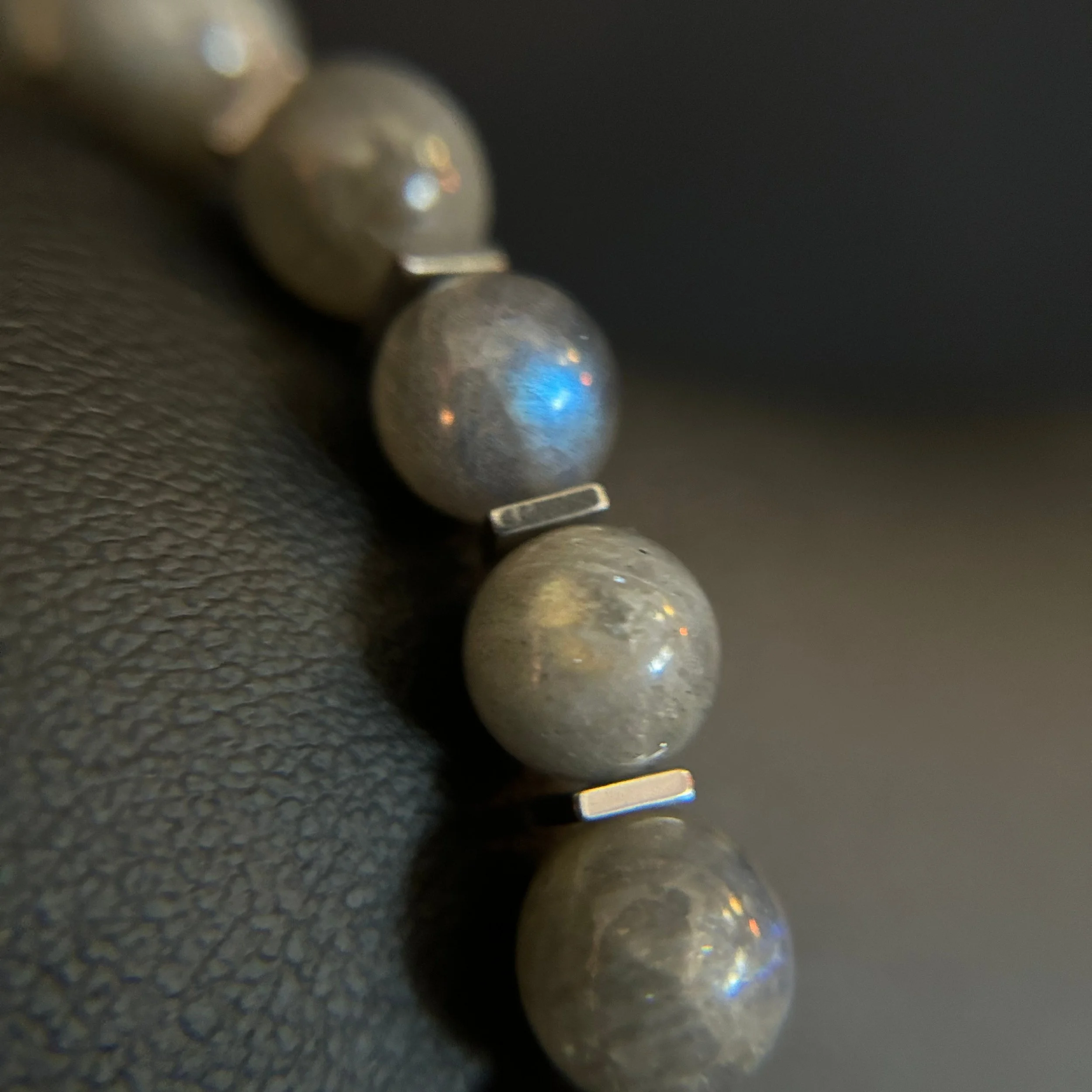 Moonline necklace detail showing polished labradorite rounds separated by small square silver spacers