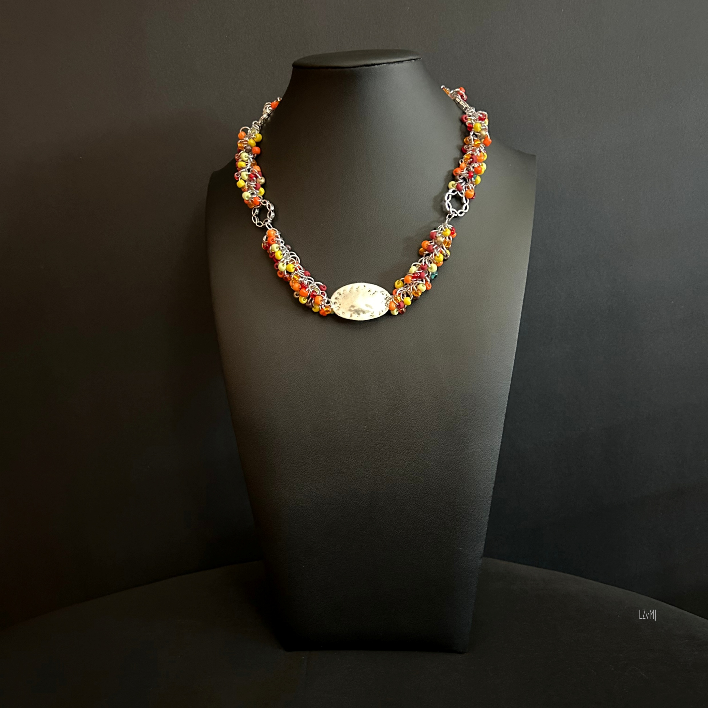 “Full view of the Autumn Tangle necklace with autumn‑color beads, silver rings, and hammered focal.”