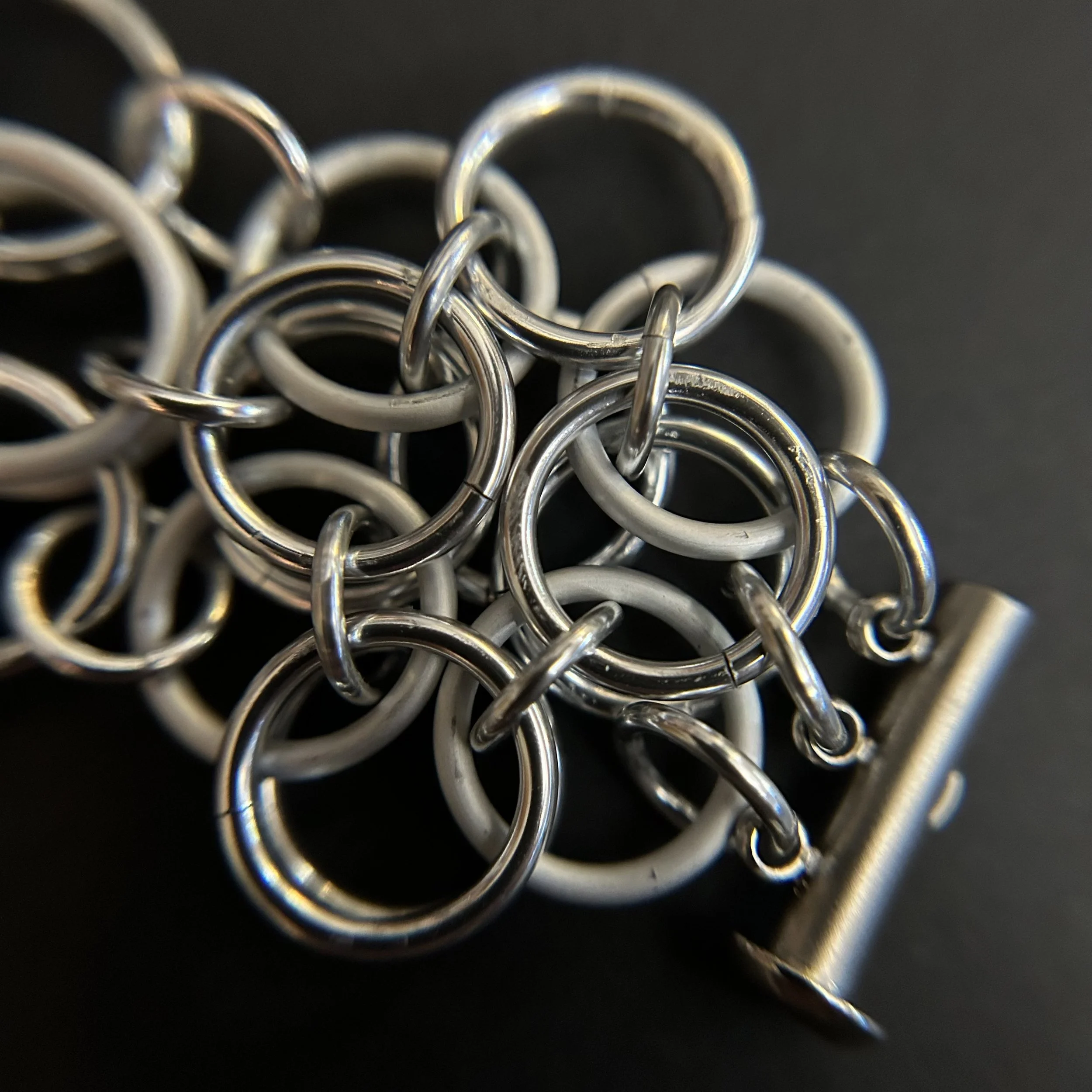 Detail image of the helm rosette weave pattern with shiny and matte silver rings