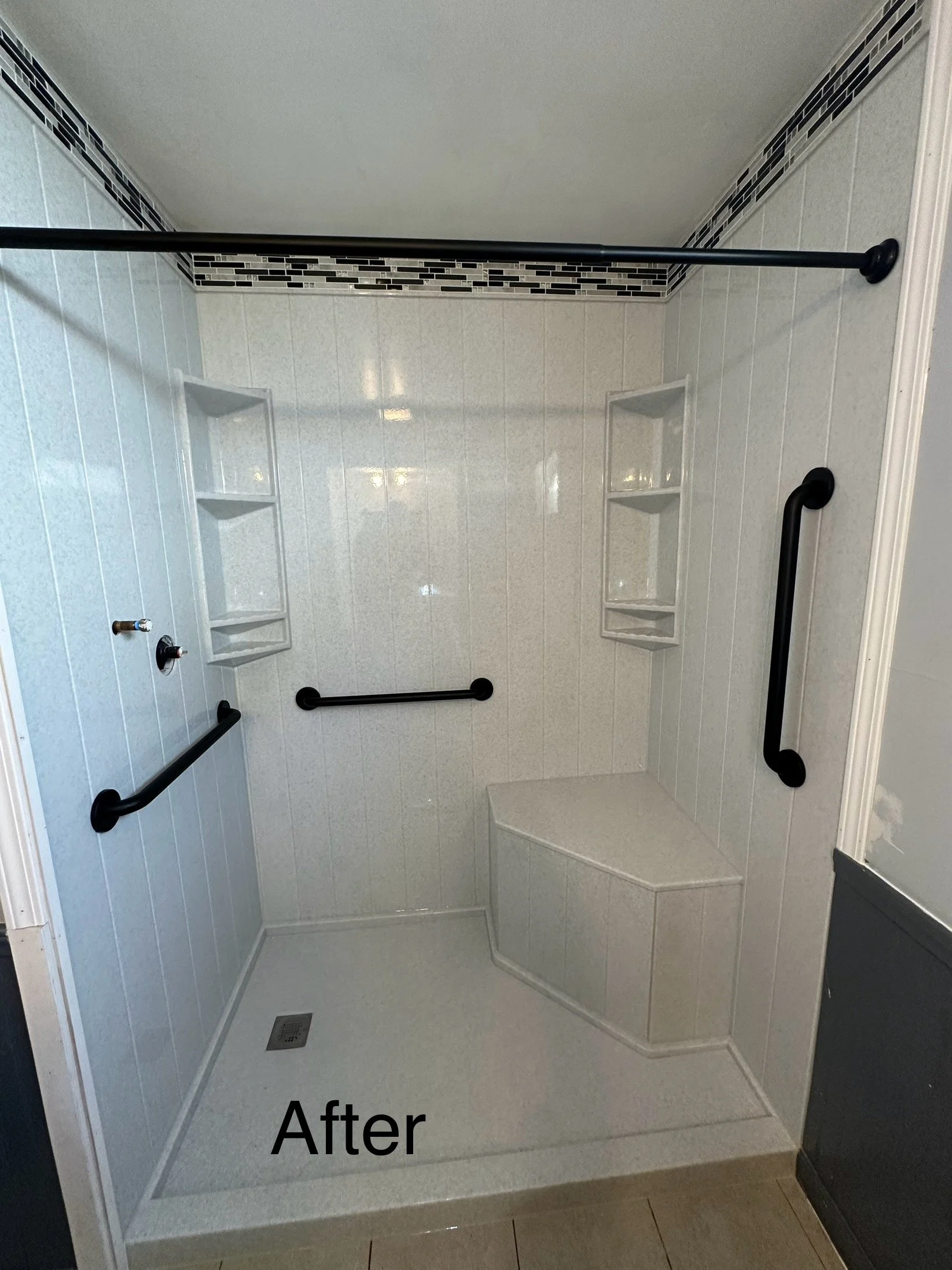 A renovated walk-in shower with beige tiles, black grab bars, built-in shelves, and a bench, with the word "After" in black text at the bottom.