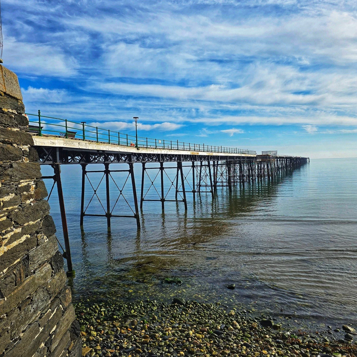 Lovely Saturday morning through Ramsey on a sunny, still, slightly hazy start to the weekend.

With the sea as calm as it is, it really makes the Queen&rsquo;s Pier look all the more striking. Heading up from the prom into town, the blossom outside t