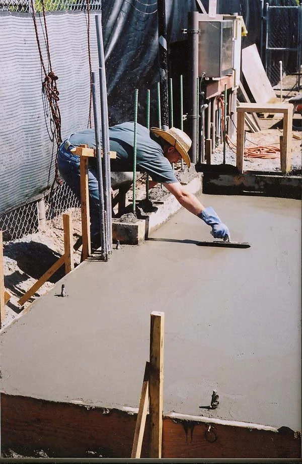 Monterey D1 Candidate Tom Reeves evens out fresh concrete.