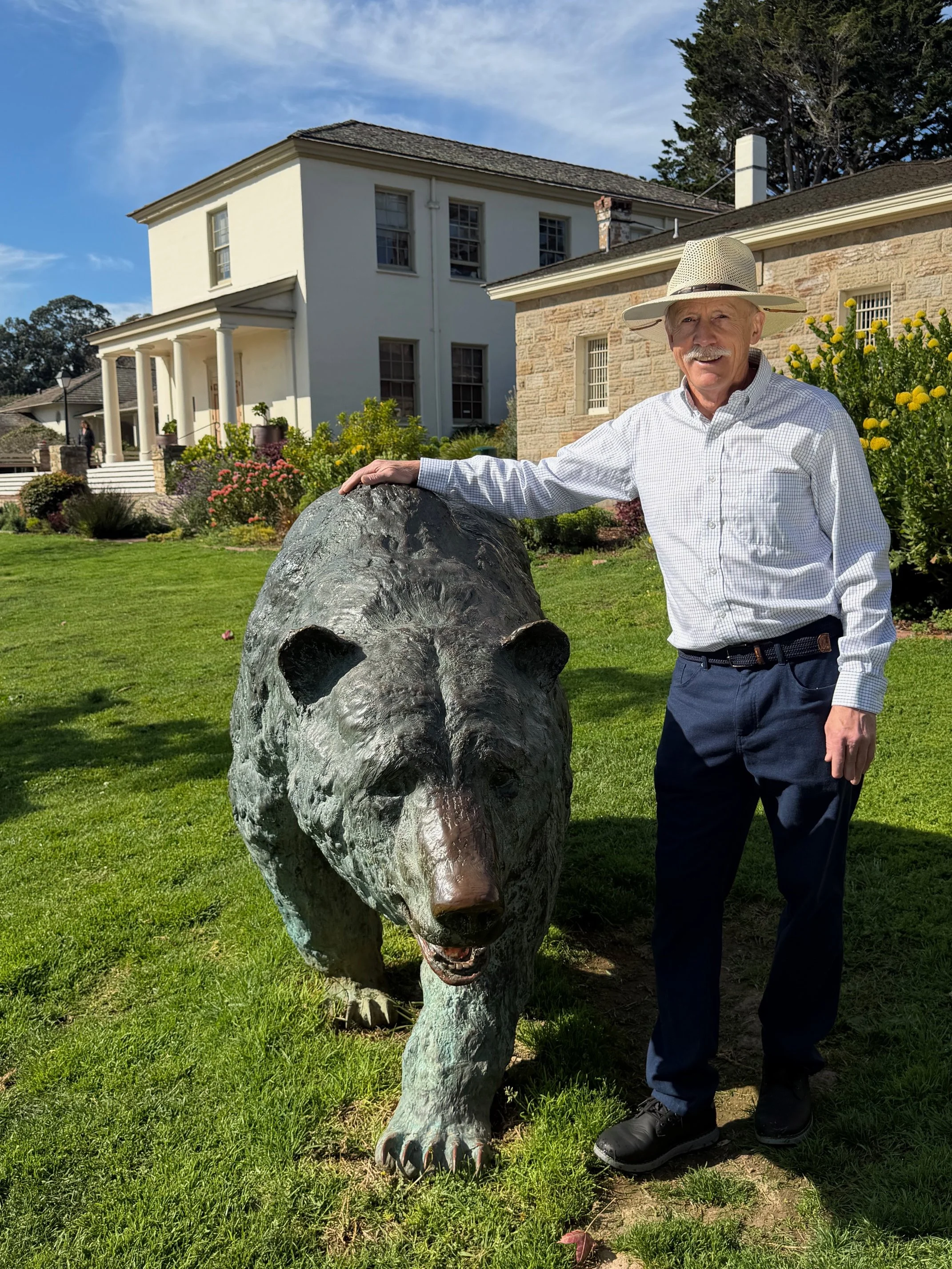 Monterey D1 Candidate Tom Reeves stands in front of Colton Hall's iconic bear statue