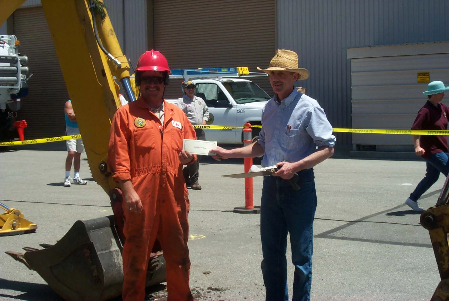 Candidate Tom Reeves presents an award to a backhoe driver in the backhoe rodeo he organized