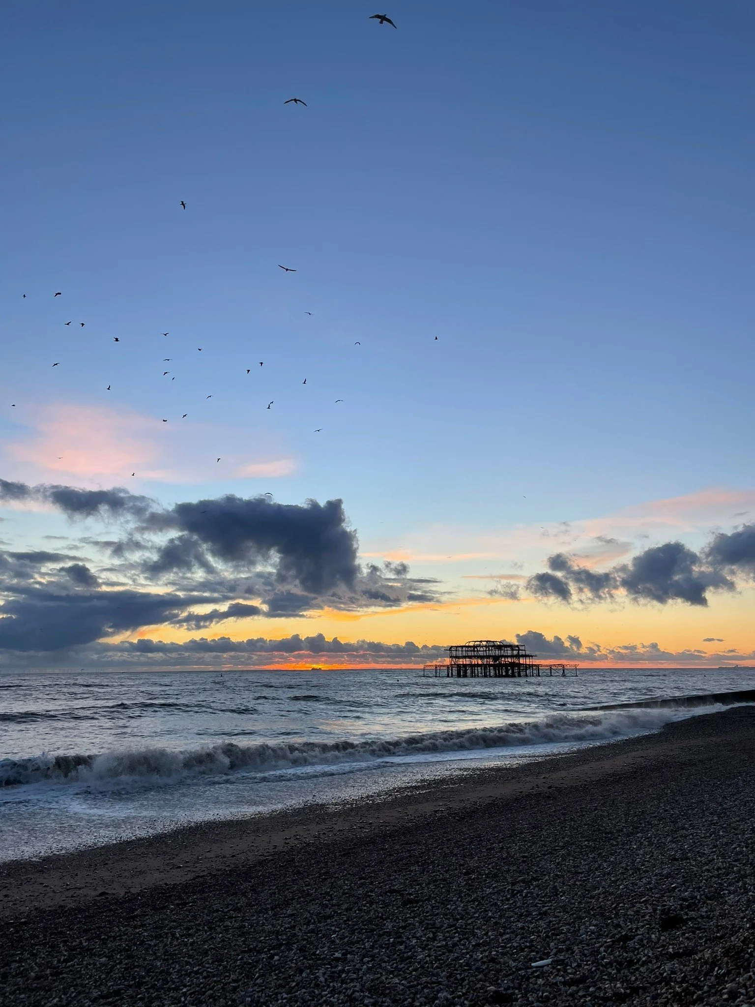 Photo of sunset behind Western Pier Brighton