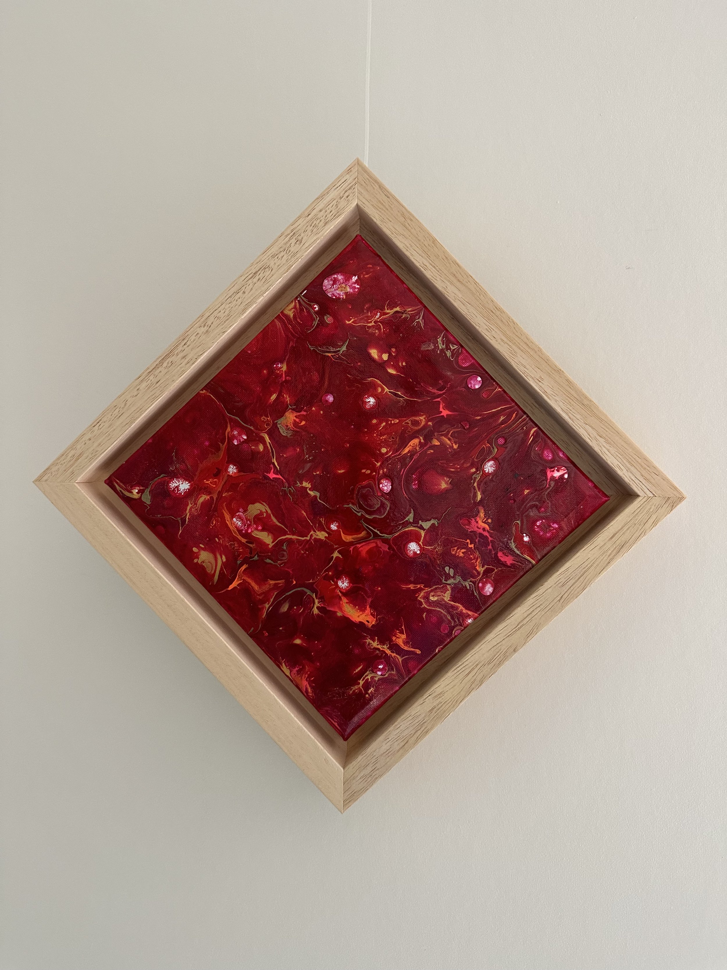 NAME: Explosion in red
DESCRIPTION: Crafted with a pouring acrylic technique, our painting boasts a glossy finish that enhances the luminosity and depth of its colors. Each layer of paint is carefully poured and manipulated to create a seamless, refl