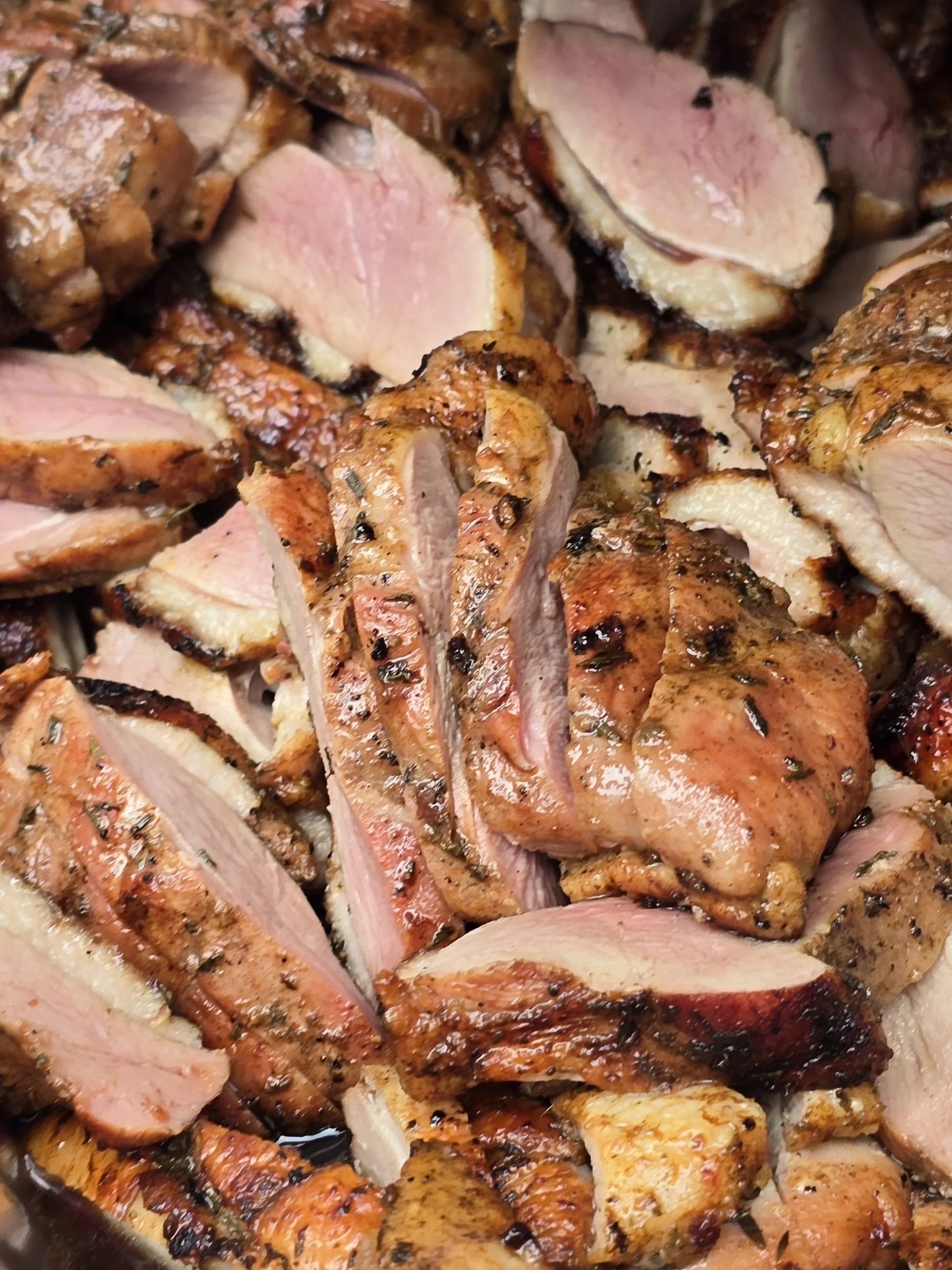 Close-up of sliced and smoked duck seasoned to perfection.