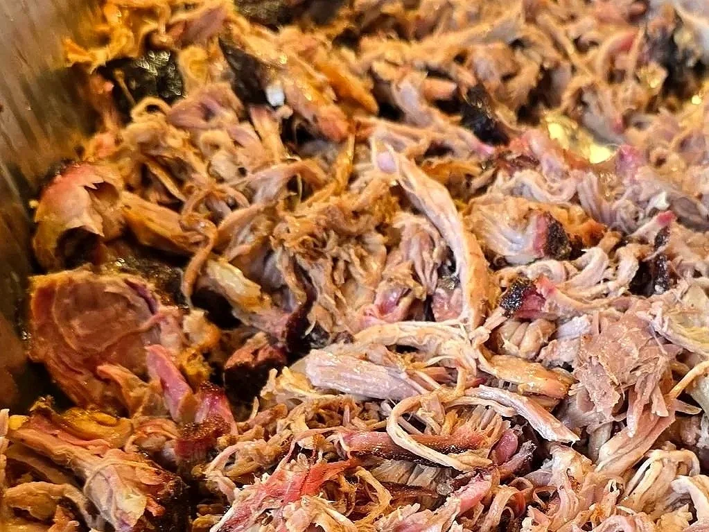 Shredded cooked meat, likely pork or beef, in a close-up view.