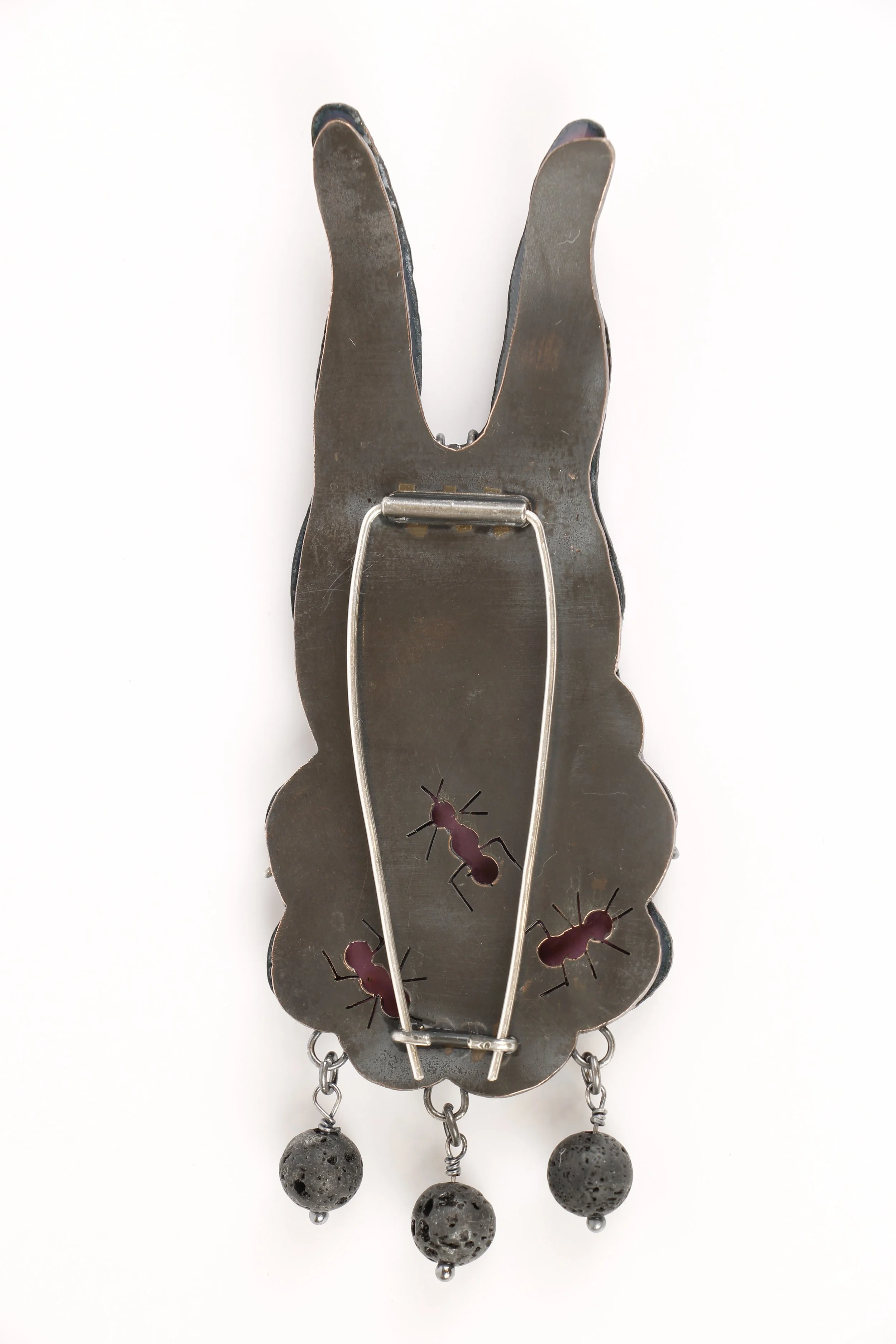 Back of rabbit brooch with ant cutouts.
