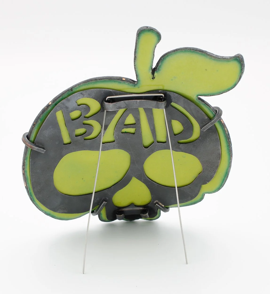 Neon sign in the shape of a skull with a pumpkin-like outline, featuring the words '13th AVE' and a pumpkin stem and leaf design.