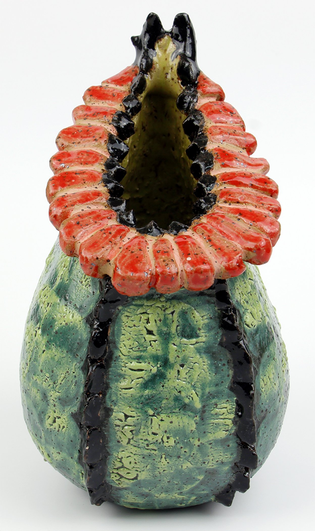 Ceramic sculpture of a pineapple with an open top, painted in green, yellow, red, and black.