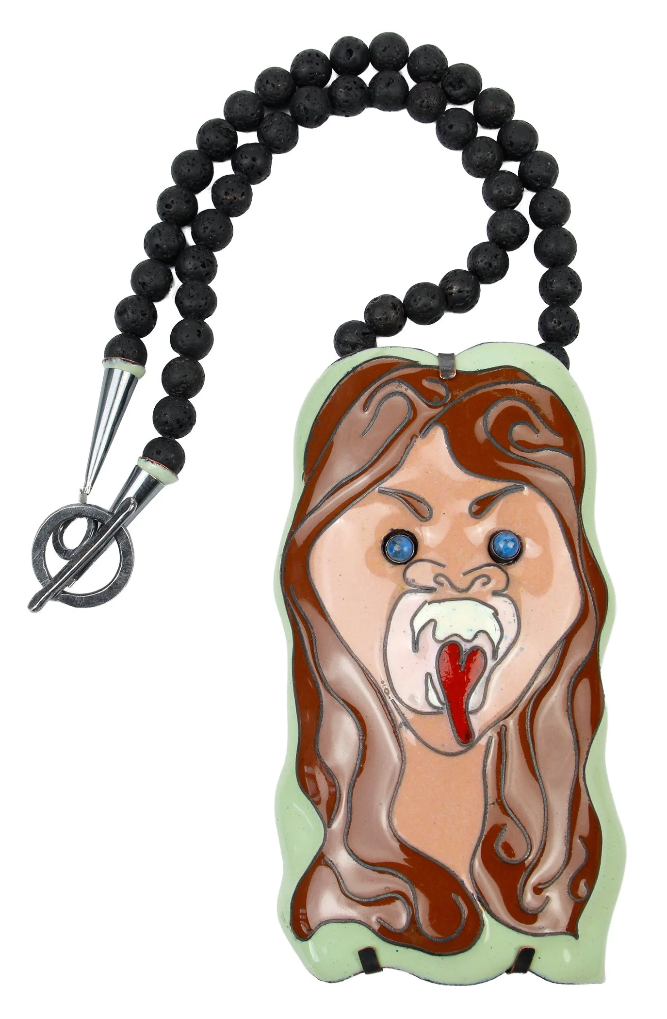A necklace featuring a pendant with an angry woman's face, her mouth open wide with red tongue showing, blue eyes, and brown wavy hair, attached to black beads and a silver clasp.