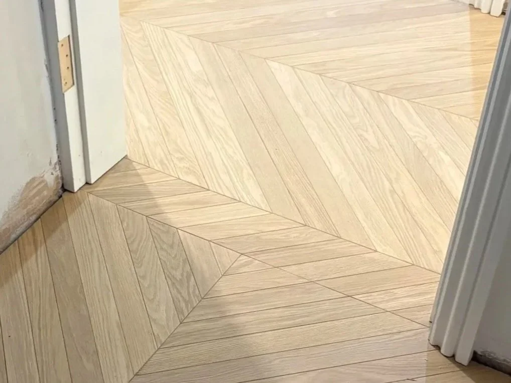 Chevron parquet. Direction change at door transition. 