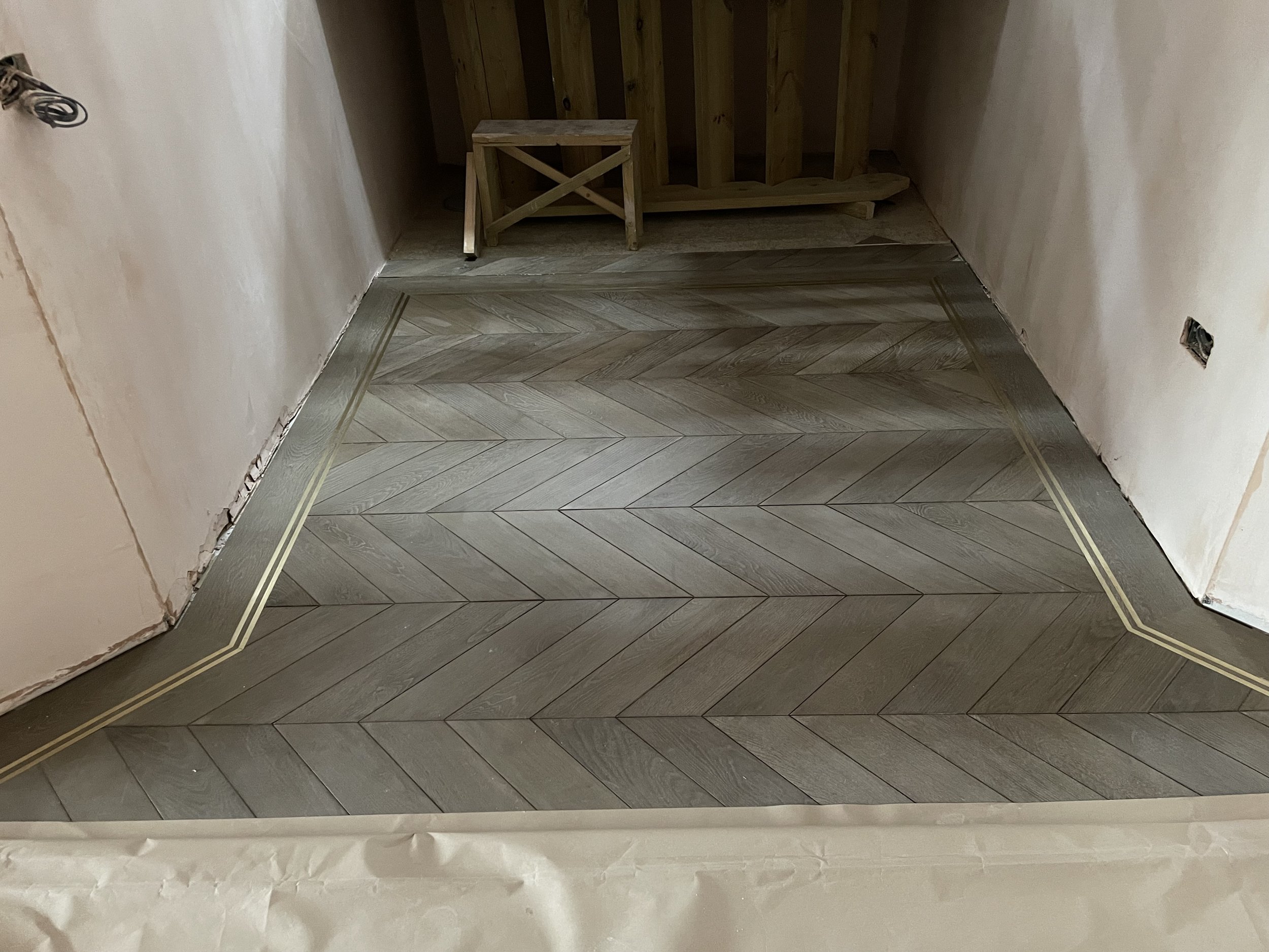 Chevron installation with brass boarder. 