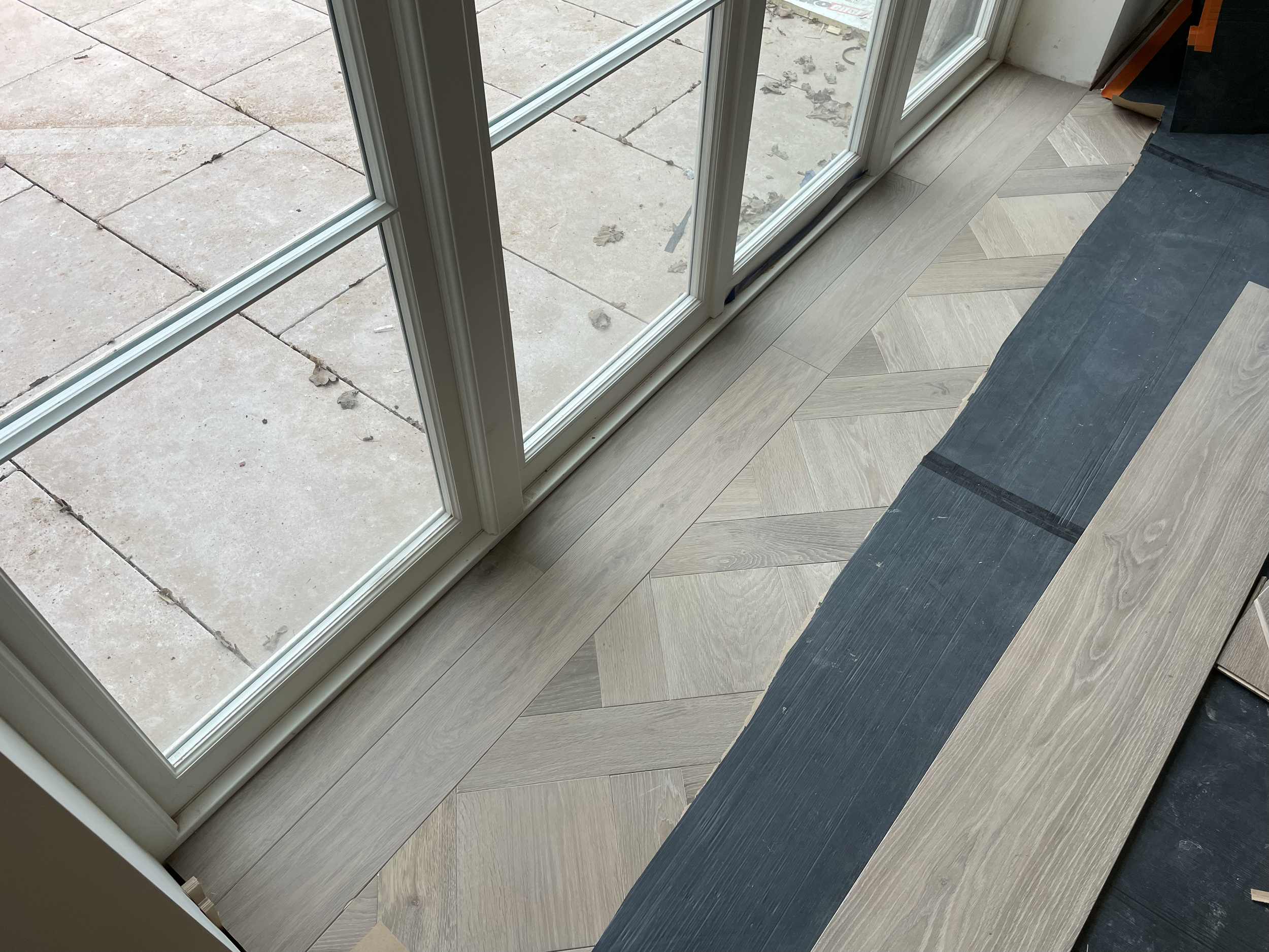 Plank threshold with basket weave pattern.