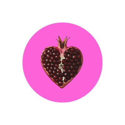 Heart-shaped pomegranate with seeds exposed on a pink background.