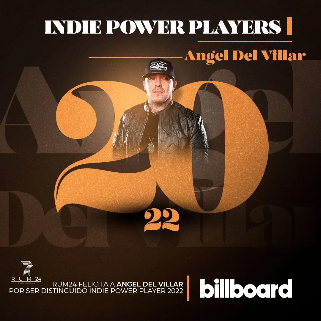 Celebratory poster featuring Angel Del Villar, celebrating his recognition as an Indie Power Player 2022 on Billboard. The background is dark with large, gold-colored number 20 and 22, with Angel Del Villar in the center wearing a black leather jacket and a baseball cap.