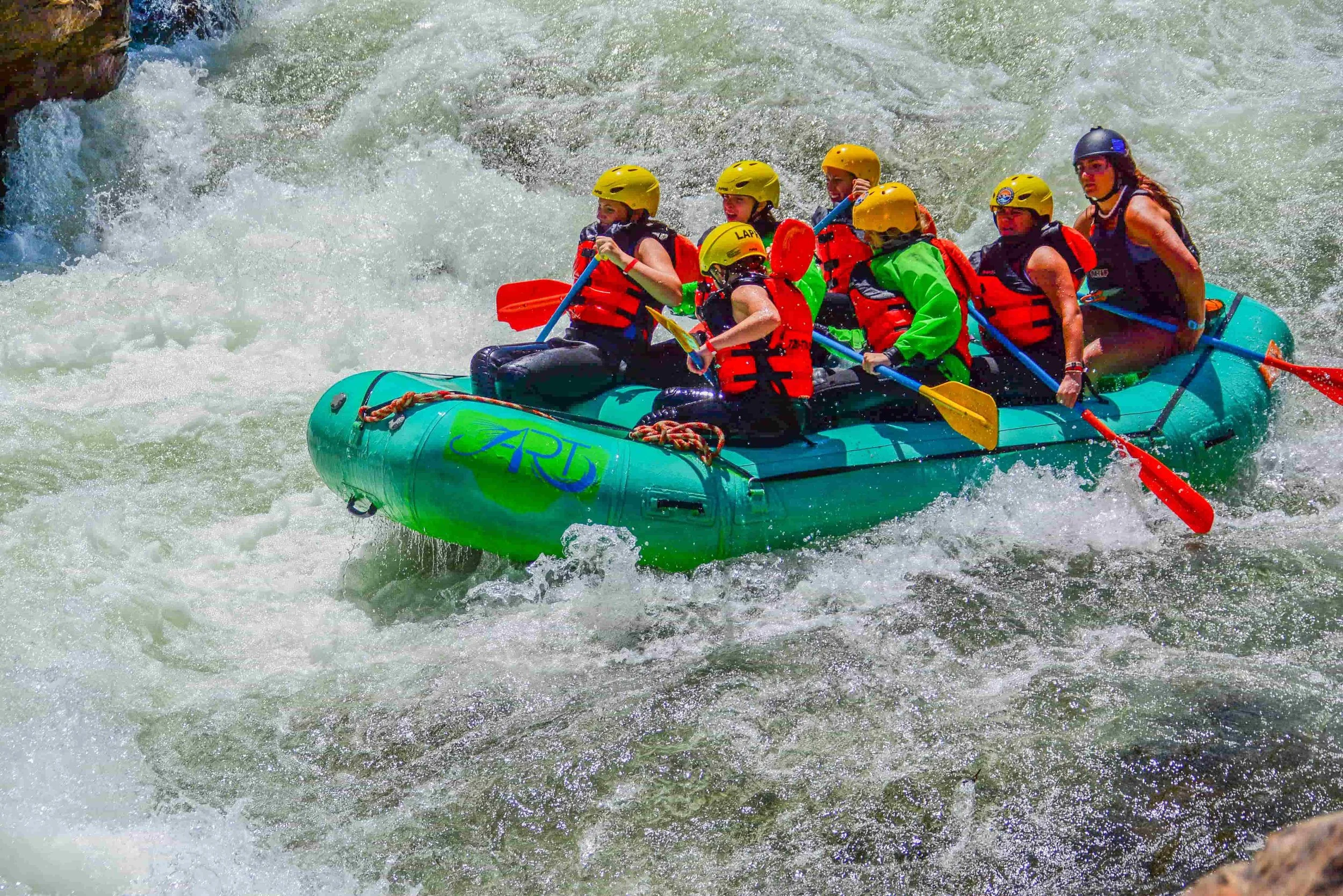 Group whitewater rafting through a rapid on Clear Creek in Idaho Springs, Colorado.