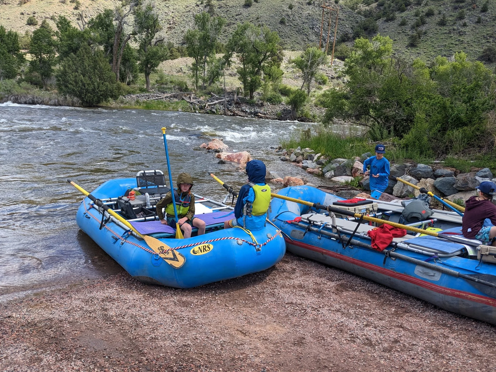 Multi-day rafting adventure on the Colorado River with tents and camp setup along the riverbank
