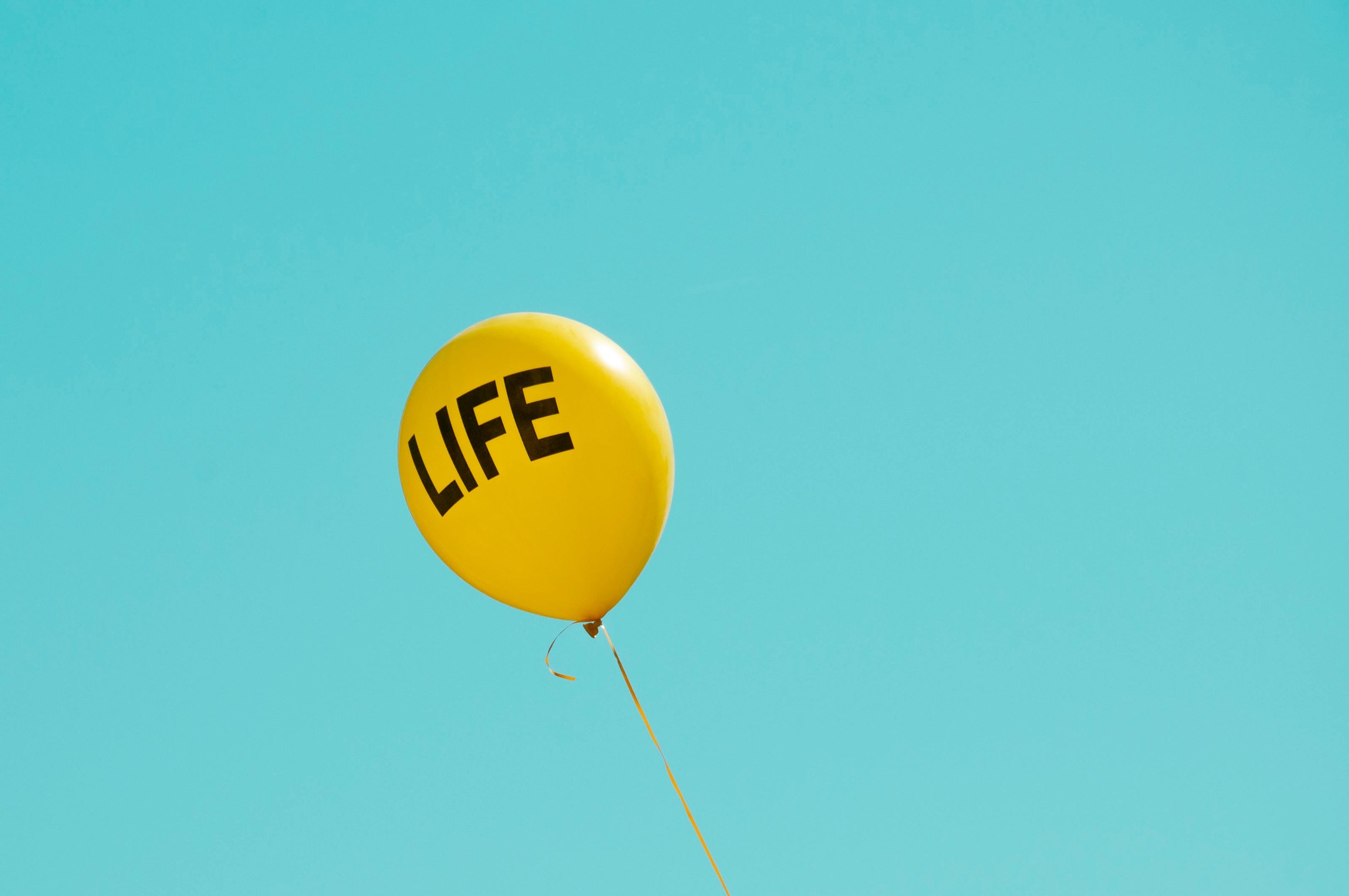 Yellow balloon with the word life on it