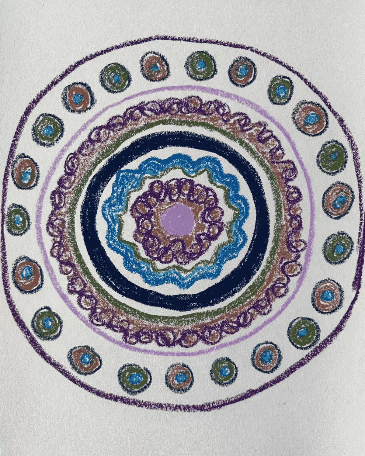 Colorful abstract circular pattern on white paper with layers of purple, blue, green, brown, and black in concentric circles.