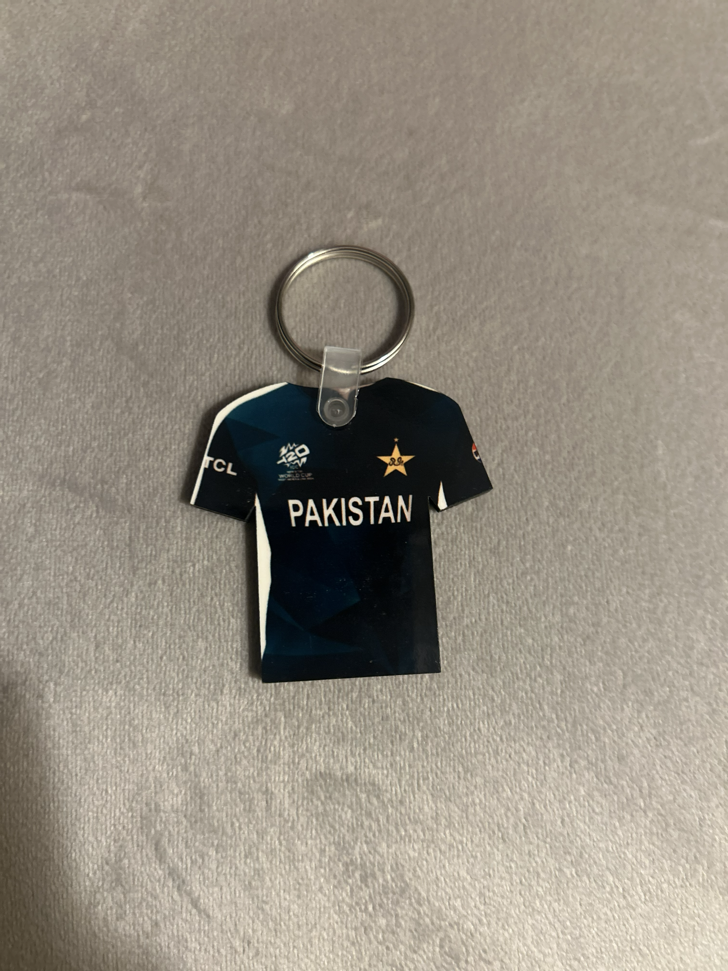 A keychain with a black sports jersey-shaped tag that has 