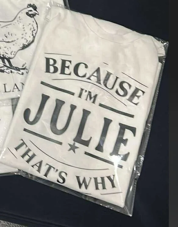 A fabric item with the text 'Because I'm Julie That's Why' printed on it, possibly a tote bag or pillow.