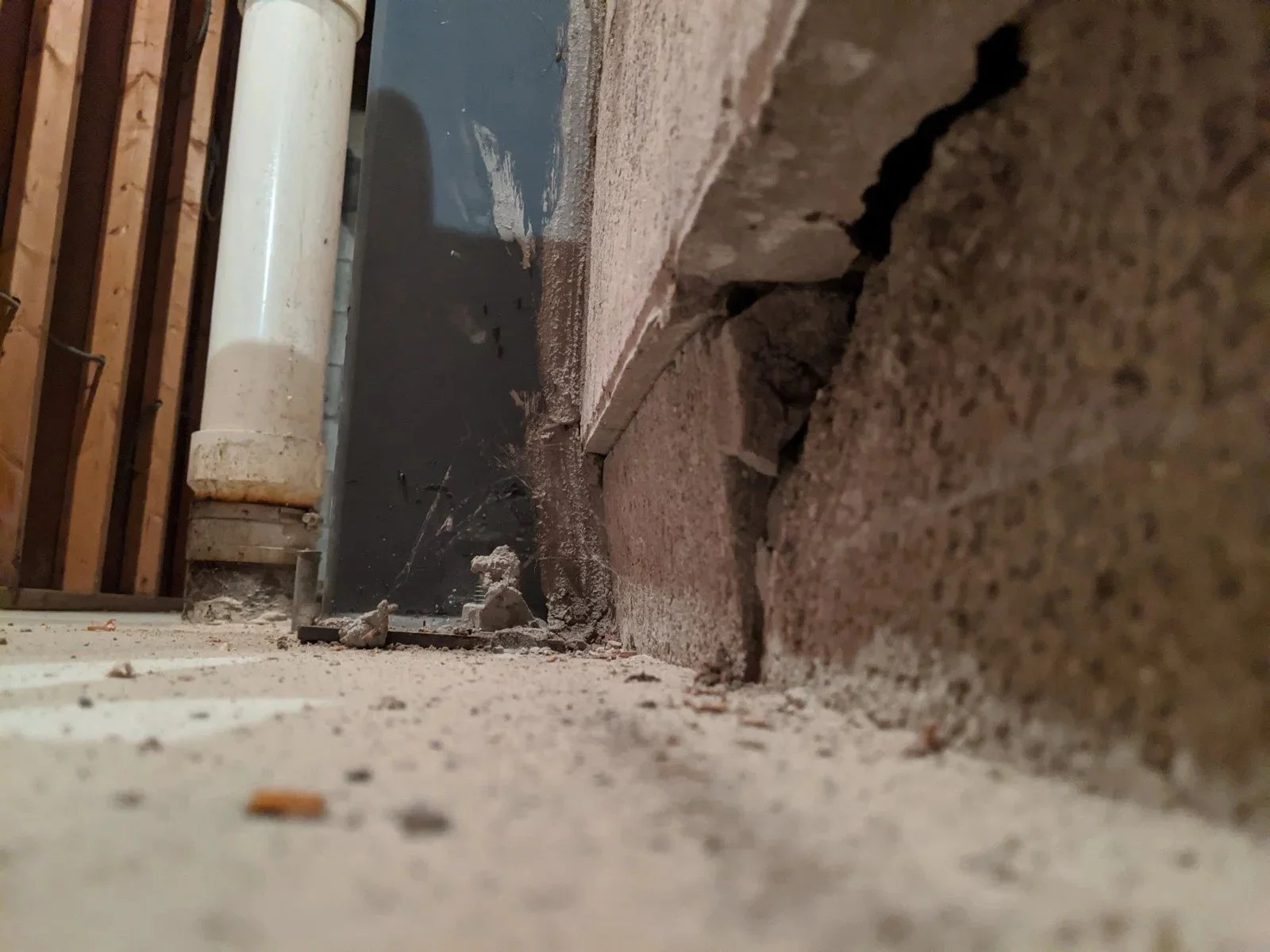 Lower course block face broken out under a wall that was braced with 1 1/2 in. of shear still in it.