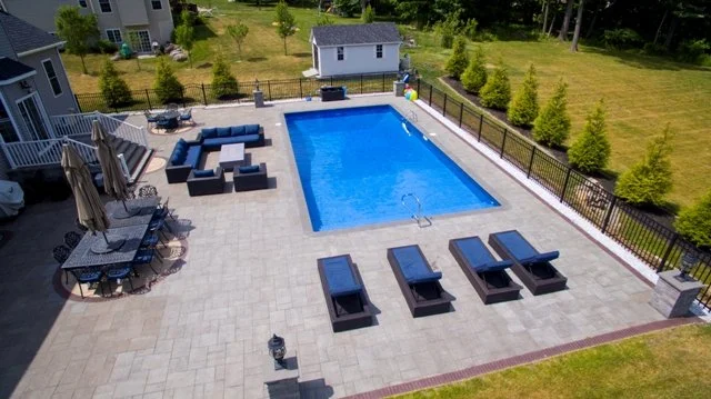 drone photo of in ground pool, patio