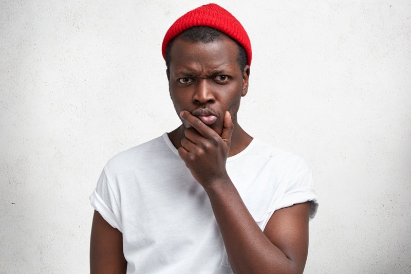 Confused Looking Man - white shirt, red wool cap