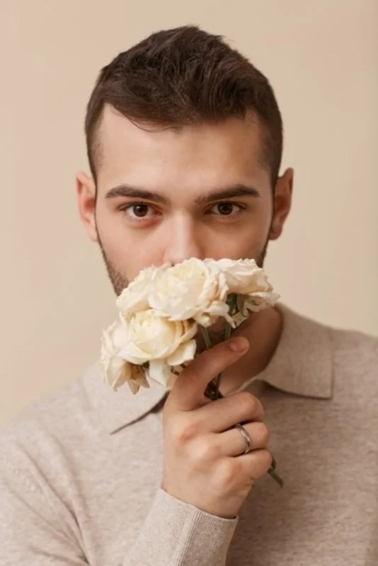 Elegant_Young_Man_Holding_Flowers