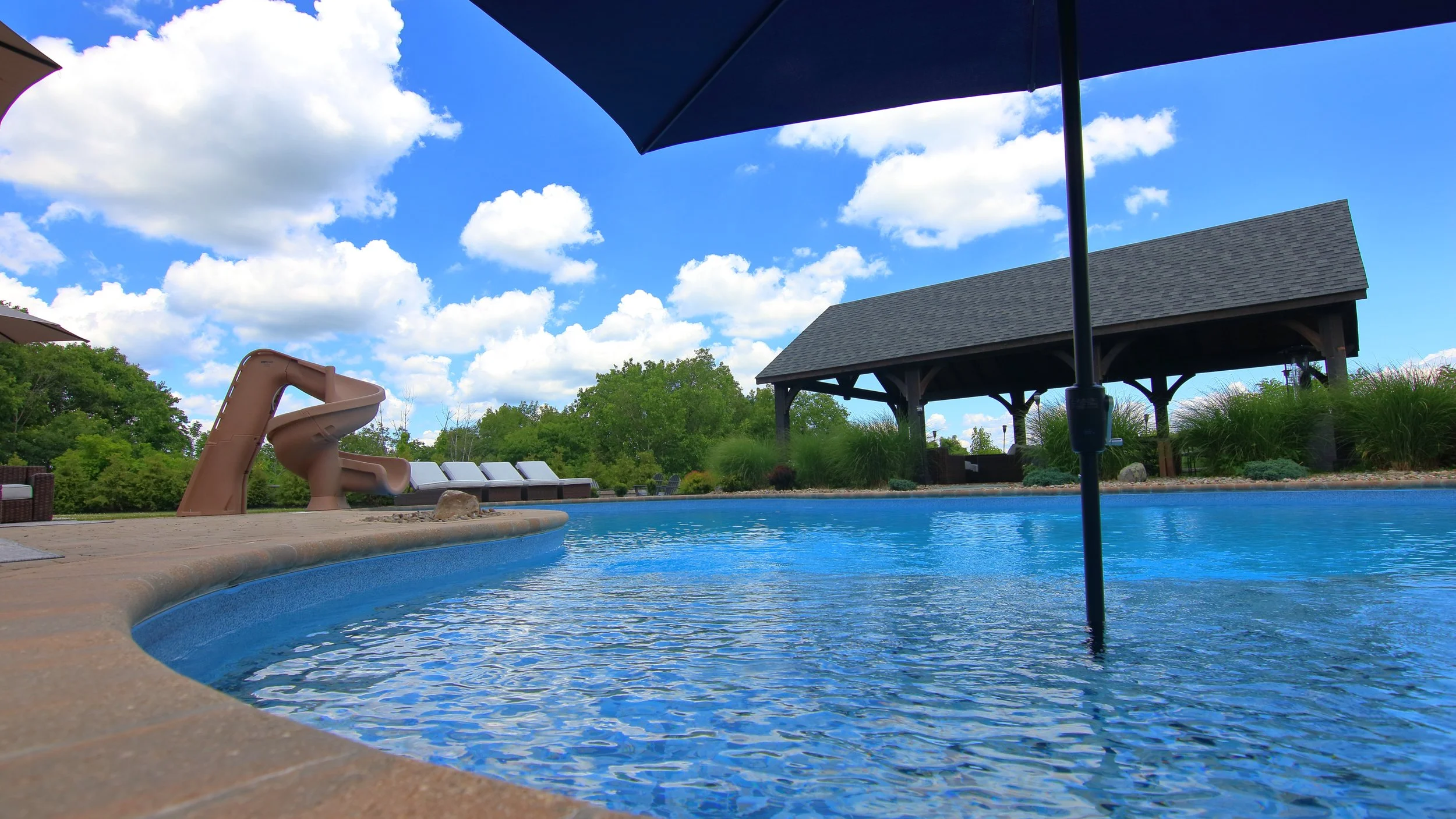 A backyard pool, with slide
